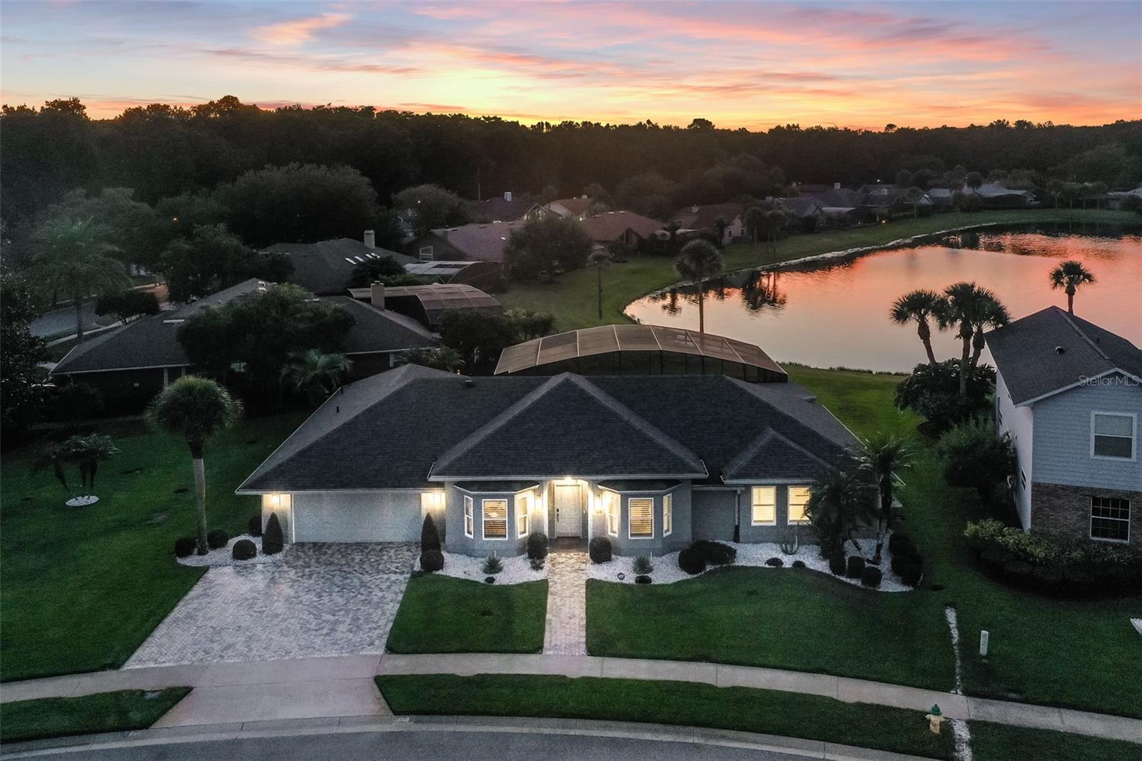 Stunning Custom Renovated Pool Home on Oversized Corner Lot in desirable Silver Lakes East. This beautifully upgraded 4-bedroom, 2-bath home sits on an oversized 1/3-acre corner lot with a picturesque view of a retention pond and fountain. Surrounded by lush, manicured landscaping, the property features 10-zone underground irrigation, paver driveway and walkway, and a fiberglass entry door that sets the tone for the elegance within. Inside, you’ll find 8’ and 10’ ceilings, real hardwood floors, porcelain tile in the bathrooms and laundry, and solid wood doors throughout. The home was completely custom renovated in 2020, including a new roof, full interior and exterior paint, plantation shutters on all windows, and automated shades on the sliding doors. Thoughtful upgrades include no-threshold flooring transitions, solid wood cabinetry, Cambria quartz countertops with backsplash, upgraded fixtures, under-cabinet lighting, and high-hat ceiling lighting. The gourmet kitchen is outfitted with top-of-the-line appliances including a built-in GE Monogram refrigerator, oven, glass cooktop, microwave, and wine cooler, plus a Bosch dishwasher and stainless-steel range hood. Bathrooms have been fully modernized, with the owner’s suite featuring an expanded walk-in shower, heated ceiling fixture, stainless grab rails, and a professionally organized walk-in closet. The outdoor living area is equally impressive: the pool and patio were completely renovated in 2023 and include a 50’ x 15’ insulated covered lanai with dual Hunter ceiling fans, a sparkling 19’ x 36’ pool with new equipment, all marble patio deck, screened enclosure, and electric heater with saltwater conversion ready to go. The pool bath is finished with custom cabinetry and a built-in blind within the glass door. Additional highlights include: a GENERAC standby whole-house generator with propane tank, all new tinted exterior windows and sliders, in-floor electrical receptacles, custom laundry cabinetry, Carrier variable-speed A/C with new ductwork and full spray foam attic insulation, and an ADT security system with 4 cameras. This home combines timeless craftsmanship with modern luxury, energy efficiency, and peace of mind—perfect for refined living and entertaining. All this and more with unbeatable proximity to great schools, world-class attractions, shopping, dining, and bustling business districts, as well as major highways. This property may be under audio/visual surveillance.