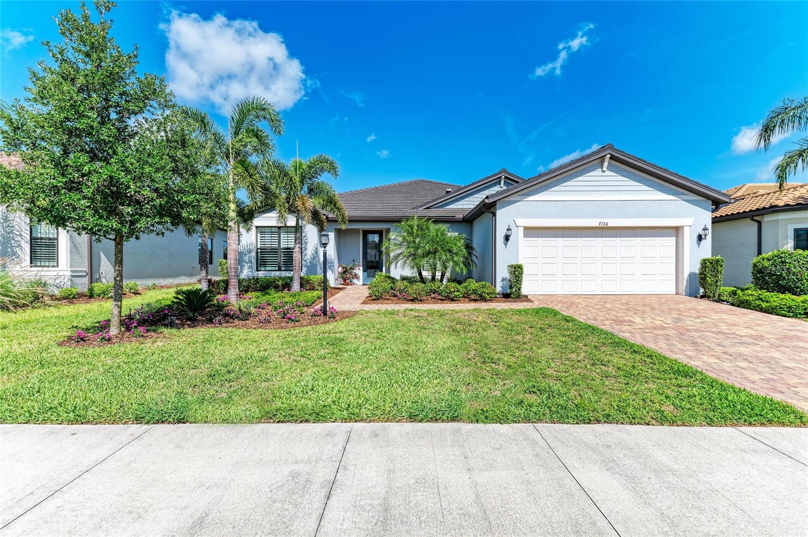 Nestled in the heart of Del Webb at Lakewood Ranch. A premier active lifestyle 55+ community. This STARDOM model blends modern comfort with timeless design. Boasting 2 master bedroom suites with a split floorplan for privacy, 2.5 bathrooms, and a flexible den/home office. Thoughtfully designed for both everyday ease and effortless entertaining. This open floor plan with over 2,200 square feet of living area screams of quality upgrades and seamlessly blends indoor and outdoor living with the 15' wide sliding glass doors to the lanai, flooding the home with natural light. Step outside to your screened lanai, perfect for morning coffee or unwinding in the evenings The gourmet kitchen takes center stage with its oversized island ( 3 inches short of 12'), quartz countertops, marble tile backsplash, built-in Kitchen Aid appliances, and walk-in pantry—making meal prep a breeze. The owner's suite is a true sanctuary with plantation shutters for privacy and the en-suite featuring dual sinks, walk-in shower, and generous walk-in closet. Storage space is more than ample throughout the home besides the over-sized laundry room, closet space, kitchen island tastefully designed lower cabinetry, coat closet etc. The extended garage provides more storage or hobby space or golf cart space all set on a well-sized 0.21-acre lot. Residents enjoy resort-style amenities including a clubhouse, fitness center, pools, pickleball, tennis, walking trails, and a full calendar of social events. Just minutes from dining, shopping, medical care, and world-famous Gulf beaches.
Live the lifestyle you’ve earned—schedule your showing today!!!