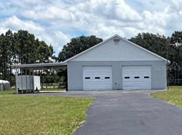 Take a look at this fantastic property, it has a 2 bedroom, 1 and a half bath mobile home with a huge 40 x 40 garage with two electric garage doors, a car lift, a bathroom, plenty on work benches and shelving, an air compressor, and a tire machine! The attached carport is 20 x 40 and offers lights and a concrete floor. All this on 2.5 acres of cleared and fully chain link fenced land with a wide paved driveway to the shop, and a sidewalk to the home. The home has been completely remodeled and offers 10x12 Florida room that is under AC, as well as a 560 sq ft screened porch. Whether you need extra room to work store and work on your toys, a safe storage space for your cool old cars, or any kind of workshop this is a great location and a great property that provides privacy and plenty of open space.