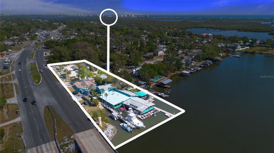 NOW THIS IS A HIDDEN TREASURE!! (; Located in a prime, high-traffic area off of U.S. 1 (approx 3,200 cars per hour) this commercial waterfront property, known as "Hidden Treasure" -- offers an exceptional opportunity for entrepreneurs looking to expand an established business or invest in a future thriving business. The property boasts nearly 1.17 acres of land plus an additional 1+ acre of water access leased through DEP. In addition, 3 well-maintained buildings, each designed to accommodate a range of business operations, from restaurants to retail and all in between plus ready for immediate use. (2 tenants already in place.)
This piece of real estate can accommodate up to 325 people at once! Alongside the buildings, there are 3 spacious docks and seawall with 16 boat slip(s) and power/water ... perfect for boat traffic, water sports rentals, or any maritime-based ventures. 
Imagine a second level ... or rooftop ... Imagine a fuel station for local boaters ... Imagine monthly rentals for boat slips ... THE ROI IS LIMITLESS WITH THIS OPPORTUNITY! 
With an ample parking lot and 95 parking spots, the property can easily accommodate high customer volumes, ensuring smooth operations year-round. Plus the opportunity for additional income. The parking lot is designed for convenience and accessibility, making it easy for patrons to enjoy everything the property has to offer or store their toys after a day on the water. 
The ample space allows for potential expansion or diversification, providing new owners with flexibility in growing their businesses and catering to the community's needs. At the heart of the property is the popular Tiki Bar and Grille, a well-established hotspot for locals and tourists alike, offering a fun and relaxing atmosphere with exceptional food and drinks. Known for its laid-back vibe, the Tiki Bar is a favorite spot to unwind, making it a lucrative business on its own. Additionally, the property also features a successful watercraft/jet ski rental business, providing customers with exhilarating water sports experiences while capitalizing on the prime waterfront location. 
Whether you're looking to invest in an established waterfront business, expand your current operations, or simply capitalize on the prime Rose Bay waterfront location, this "hidden treasure" offers tremendous value and potential. With its unique combination of commercial buildings, parking lot space, ability to build up, waterfront access, docks/slips and a successful existing business portfolio, this property stands out as a hidden gem in the heart of a thriving community! Don't wait ... CALL TODAY FOR MORE INFO! ALL INFORMATION DEEMED TO BE TRUE BUT NOT GURANTEED.
