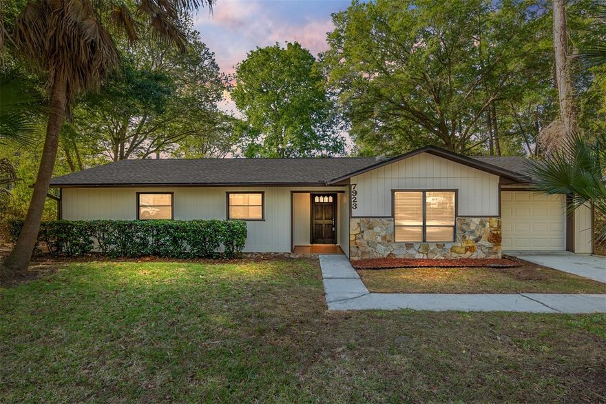 Welcome to this beautifully updated 3-bedroom, 2-bath home nestled in the heart of Southwest Gainesville. Designed with both comfort and style in mind, the home features a fully renovated kitchen complete with stainless steel appliances, modern countertops, a stylish backsplash, and a spacious center island with a breakfast bar—perfect for casual dining or entertaining. Luxury vinyl flooring flows throughout, complementing the bright and open layout. The generous living room is filled with natural light and connects seamlessly to the dining area and a versatile sunroom or flex space, offering plenty of room to relax, work, or host guests.

The oversized primary suite provides a peaceful retreat, featuring a walk-in closet and a private view of the expansive backyard. One of the additional bedrooms also includes a walk-in closet, adding to the home’s thoughtful storage options. Step outside to enjoy a truly inviting outdoor space, where mature palm trees and blooming camellias create a serene, backyard oasis—ideal for morning coffee or evenings gathered around a fire pit. A fully fenced, oversized yard offers both privacy and plenty of room to play or garden.

Additional highlights include a one-car garage with built-in shelving and a dedicated laundry area for added convenience. With a newer roof and a prime location just minutes from Publix, Celebration Pointe’s shopping and dining, Archer and Newberry Roads, as well as the scenic trails and farmers market at Haile Plantation, this home combines modern updates with unbeatable accessibility.