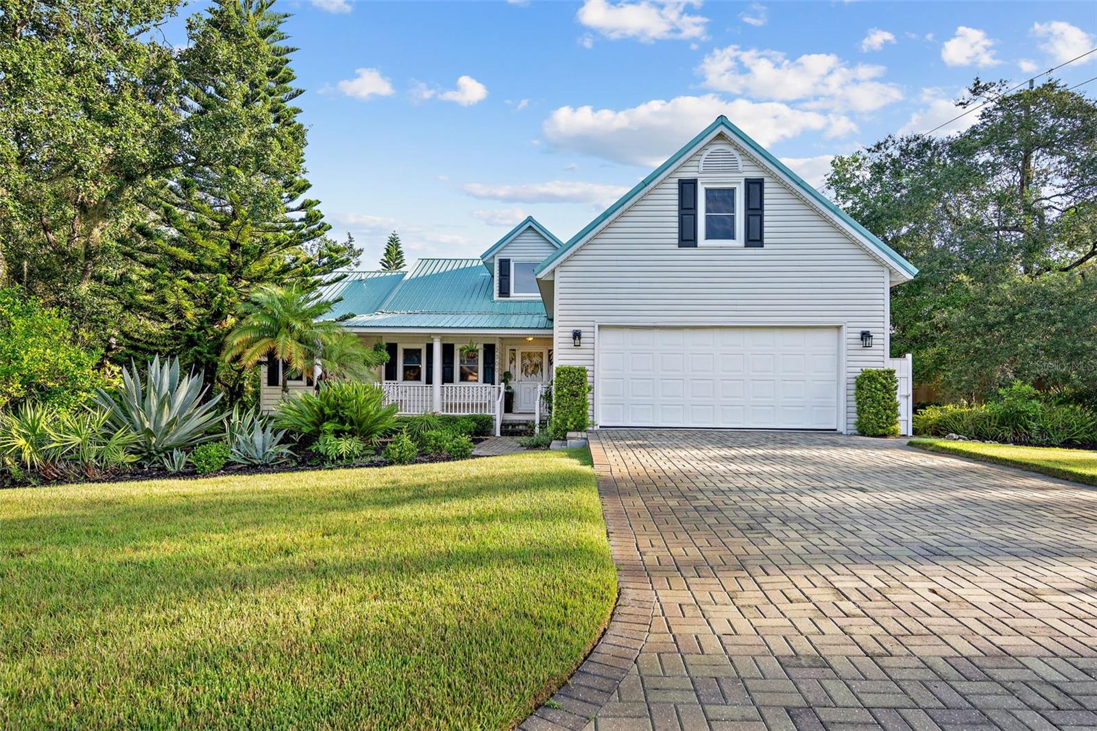 Experience the ultimate in beachside living on this prime corner lot within a charming 32-lot community. This stunning 4-bedroom, 2-bathroom home with a 2-car garage showcases beautiful wood floors throughout, a durable metal roof, and hurricane-resistant windows and doors. The kitchen is a chef's dream, featuring upgraded, extra-large cherry cabinets with soft-close drawers and convenient pull-out shelving, complemented by Corian countertops and stainless steel appliances.
Enjoy the convenience of a 3-zone in-ground sprinkler system, complete with its own well, and an upgraded Zoysia sodded yard. The meticulously maintained garden is a tropical paradise, boasting an array of palms, citrus trees, hardwoods, and native plants. A brick paver driveway leads you to the home, enhanced by stamped concrete edging around the vibrant flower beds. For outdoor comfort, there's a hot/cold shower, and the property is secured by a 6-foot Cyprus wood fence along the rear, with an HOA association stucco fence bordering the roadside. Don’t miss the opportunity to call this exquisite property your home!