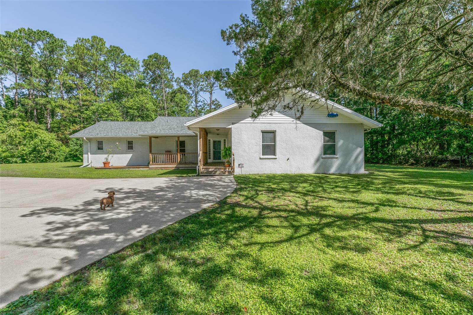 This beautiful home has everything!! It is located in St. Johns County which has A Rated schools!! Sitting on almost an acre, with small pond, private pool , detached garage, this house has everything. Primary suite has custom walk in closet ready for fashionistas. Sliders out to the back for that private walk to the pool. The dining room is the central heart of the home. Wood burning fireplace for that warm cozy feeling. Huge eat-in kitchen to satisfy any chef. Then there is the second suite. The 2nd suite (3rd bedroom) has its own entrance. And the walk in closet is my personal favorite. You have to see it! Perfect for adult children, generational wing or live-in nurse or nanny. Has a door to close it off from the rest of the house. Use it as a rental. The detached garage is perfect for all your weekend toys. Complete with a full bathroom and urinal!! Screened in pool has hot tub for relaxation. extra outbuildings and a well pump house. This house is close to everything!