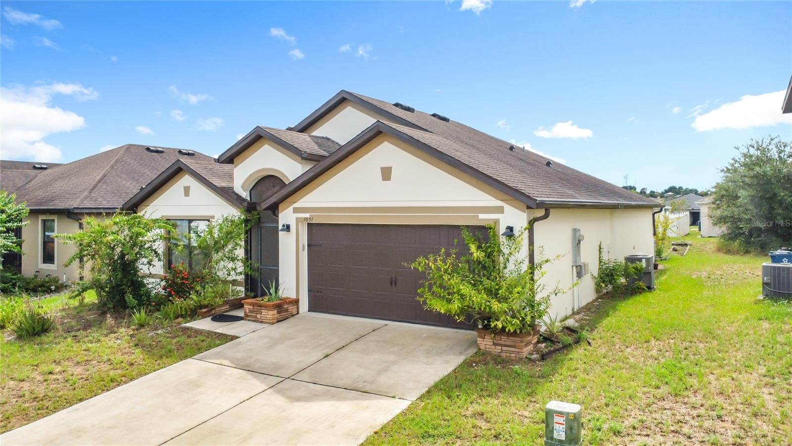 **Over $75,000 in upgrades!** This beautifully enhanced home showcases top-tier improvements, starting with a fully paid-off solar panel system ($20,000) that drastically reduces energy costs to minimal meter charges, and a stunning bathroom renovation by *Love Your Bath* ($24,000) featuring a lifetime transferable workmanship warranty. Premium manufactured laminate flooring and plush bedroom carpeting ($12,000) add both style and comfort. At the same time, a full-house Puronics water softener and purification system ($5,500) with a lifetime transferable warranty ensures exceptional water quality throughout. Exterior enhancements include custom rain gutters ($2,500), a screened porch and patio ($1,500), and rainwater harvesting barrels for garden irrigation ($1,200). Inside, the home features smart technology upgrades, including WiFi-enabled Alexa-controlled switches, a Nest thermostat, and Alexa-controlled ceiling fans in the bedrooms and living areas. Complementing these upgrades are energy-saving features, such as motion-sensor lighting in the bathrooms and laundry room, as well as a UV light in the A/C system for mold-free air and regular system maintenance. Security is enhanced with a Ring video doorbell, while upgraded appliances—including a Samsung washer and dryer ($2,000), a double-door refrigerator ($1,500), and a range with a built-in air fryer ($1,200)—add convenience and style. The garage is equally functional with a WiFi-enabled garage door opener ($500) and built-in storage shelving ($1,000). Every detail has been thoughtfully designed for modern living, combining efficiency, comfort, and long-term value in one move-in-ready package.