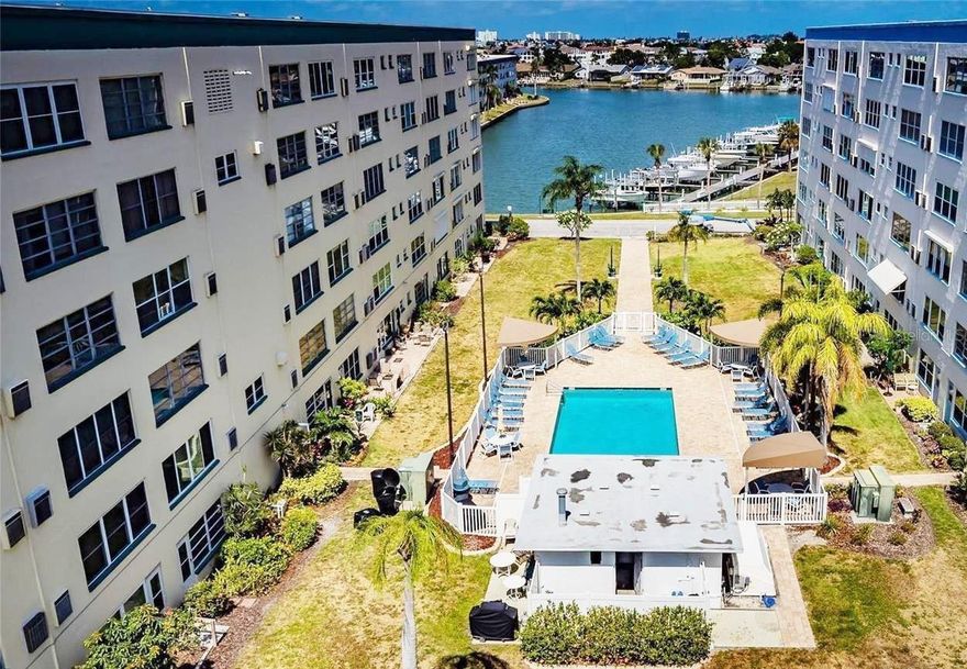 Experience the perfect blend of comfort and style in this beautifully renovated top-floor 2-bedroom, 2-bathroom in the Jamison building at Town Shores of Gulfport ... a sought-after premier 55+ community just steps away from Gulfport Village. Every detail has been thoughtfully upgraded, making this home truly move-in ready. Step inside to discover brand-new luxury vinyl flooring throughout, enhanced by modern recessed lighting and updated fixtures that create a bright, welcoming atmosphere. Natural light pours in through new, hurricane rated energy-efficient windows, adding to the airy feel of the space. The modern kitchen is a standout feature, complete with sleek granite countertops, a spacious island ideal for entertaining, and stainless-steel appliances. Both bathrooms have been fully renovated including plumbing, modern fixtures, vanities, toilets and floor-to-ceiling ceramic tile in the shower and around the bathtub in guest bathroom.. New pocket doors have been added between the living room and sunroom providing privacy for guests. Relax and unwind while enjoying beautiful partial views of the water and sparkling community pool right from your living space. The top-floor location offers added privacy and tranquility, making it the perfect retreat. The monthly HOA fee includes a Spectrum Bulk internet and wireless package, natural gas for cooking, heat and hot water, flood and building insurance, and pool, landscaping and exterior maintenance. Town Shores has its own private marina and slips (as they become available), 4 heated pools, an active Clubhouse with weekly social events, a tennis/pickleball court, shuffleboard, bocce ball and kayak storage. This vibrant community is just a short distance from the fun, active and artsy village of Gulfport and its famous Tuesday Fresh Market and lively First Friday Art Walks. You are also just blocks away from the Gulfport public beach, restaurants, quaint inns, cafes, art galleries and boutiques! Town Shores is conveniently located just 30 minutes from Tampa International Airport and is a short drive to the cultural mecca of downtown St. Pete and the award-winning Gulf coast beaches. Schedule a showing today for this upbeat and modern unit around the corner from Gulfport Village! Whether you’re looking for a full-time residence or a seasonal getaway, this condo delivers style, convenience, and a picturesque setting all in one.