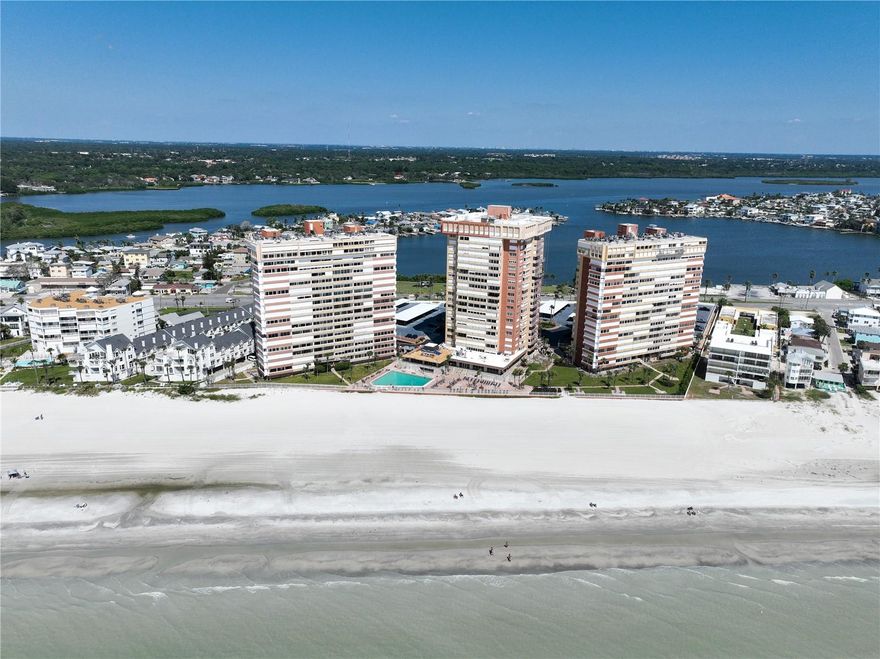 NO STAIRS, NO ELEVATOR, NO COMPROMISE.  FULLY RENOVATED BEACHFRONT PARADISE IN REDDINGTON SHORES 
Discover the perfect blend of convenience and coastal elegance in this exceptional main entrance level residence at prestigious Redington Towers, where luxury living meets effortless accessibility. Imagine never waiting for an elevator or climbing a single stair to reach your slice of paradise. This fully renovated and updated two-bedroom, two-bath sanctuary offers the rare luxury of main-level living (1st floor above the parking garage and the same level as the main parking deck) with immediate access from the elegant lobby, making it ideal whether this becomes your everyday retreat or the perfect escape for weekend getaways and extended vacations.
From your private sunset-gazing position, embrace the best of both worlds with sweeping water views of the sparkling Gulf of Mexico.  Start your mornings watching the sun dance along the sparkling blue Gulf waters and then end your evenings as the sun melts into the Gulf, all from the comfort of your two private balconies. Every detail has been carefully considered in this complete renovation, featuring custom window coverings throughout and a chef's kitchen with granite countertops, premium stainless steel appliances including a slide-in range, abundant storage with a large pantry, and a convenient breakfast bar. The primary suite sanctuary boasts private balcony access, an updated ensuite bath with marble counters and custom glazed vanities, and generous walk-in closet space, while the flexible second bedroom also offers a walk-in closet, updated bath with marble counters and custom glazed vanities, and board-approved space for in-unit washer/dryer installation. Enjoy peace of mind with impact-rated sliding doors, and one assigned parking space.
Redington Towers transforms daily life into a vacation experience with 24/7 gated security for ultimate peace of mind, private beach access via secure walkway with no crowded public beaches, a heated resort-style pool with changing facilities, EV charging stations, and generous storage for bikes, kayaks, and paddleboards. This unit offers an additional storage area plus the ability to create an in-unit laundry.  The community center is getting a full refresh and will feature a state-of-the-art fitness facility, social rooms, and a beachside clubhouse. Step outside your door to discover Boca Ciega Millennium Park for nature trails and kayaking adventures, local dining and shopping within minutes, easy trolley access to Treasure Island, John's Pass Village, and Clearwater Beach, with Tampa International Airport just 45 minutes away.
Whether you're planning frequent visits to your coastal retreat or making this your year-round residence, the main entrance level location offers unmatched convenience with effortless access for guests of all ages, easy move-ins and deliveries, quick exits for beach days and adventures, and makes it perfect for full-time or part-time living. This is more than a condominium—it's your personal gateway to the Gulf Coast's most coveted lifestyle, where every day feels like a vacation and coming home is always effortless. Schedule your private showing today and step into coastal luxury redefined.