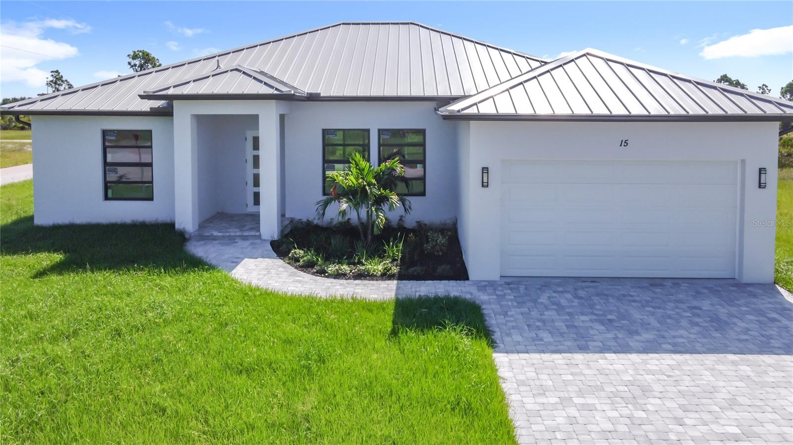 NEW CONSTRUCTION!!! CUSTOM DESIGN!! Welcome to the cozy and green community of Rotonda Sands, a laid-back neighborhood perfect for relaxed Florida living! This beautiful new home offers over 2,000 sq. ft. with 3 bedrooms, 2 bathrooms, open split floor plan, high ceilings ranging from 9 to 13 feet, 8-foot doors throughout, hurricane impact windows and doors, LVP flooring throughout and tile in bathrooms. The kitchen features quartz countertops, pantry closet, stainless steel appliances, over 8-foot long island with farmhouse sink and garbage disposal, and 42-inch cabinets. The master suite includes two walk-in closets and sliding glass doors to the lanai, while the master bath offers double sink vanity, walk-in shower, soaking tub, private toilet area and large window for natural light. Spacious laundry/utility room comes with utility sink and plenty of space for extra storage. Living room area opens to a 39-foot screened lanai finished with pavers, perfect for relaxing while enjoying Florida nature views. Additional features include a durable metal roof and pavers on the driveway. Conveniently located near beaches, parks, schools, shopping, restaurants and more—this brand new home is ready to welcome you!