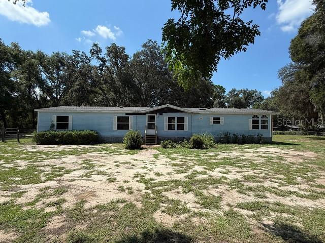 Discover true country living on 6.72 beautiful acres in Groveland! This spacious 4-bedroom, 2-bath manufactured home (built in 1997) offers over 2,000 sq. ft. of comfortable living space with room to grow. The open floor plan features an oversized living room with a cozy fireplace, a bright kitchen with generous dining space, and a split bedroom layout for added privacy. The primary suite is set apart from the other bedrooms, and the open laundry area adds convenience. Outside, you’ll find a fenced property with a pond, perfect for enjoying the outdoors and keeping animals secure. A large metal shed with a garage door provides plenty of storage for equipment, vehicles, or projects. Bring your vision and make this property your own country retreat!