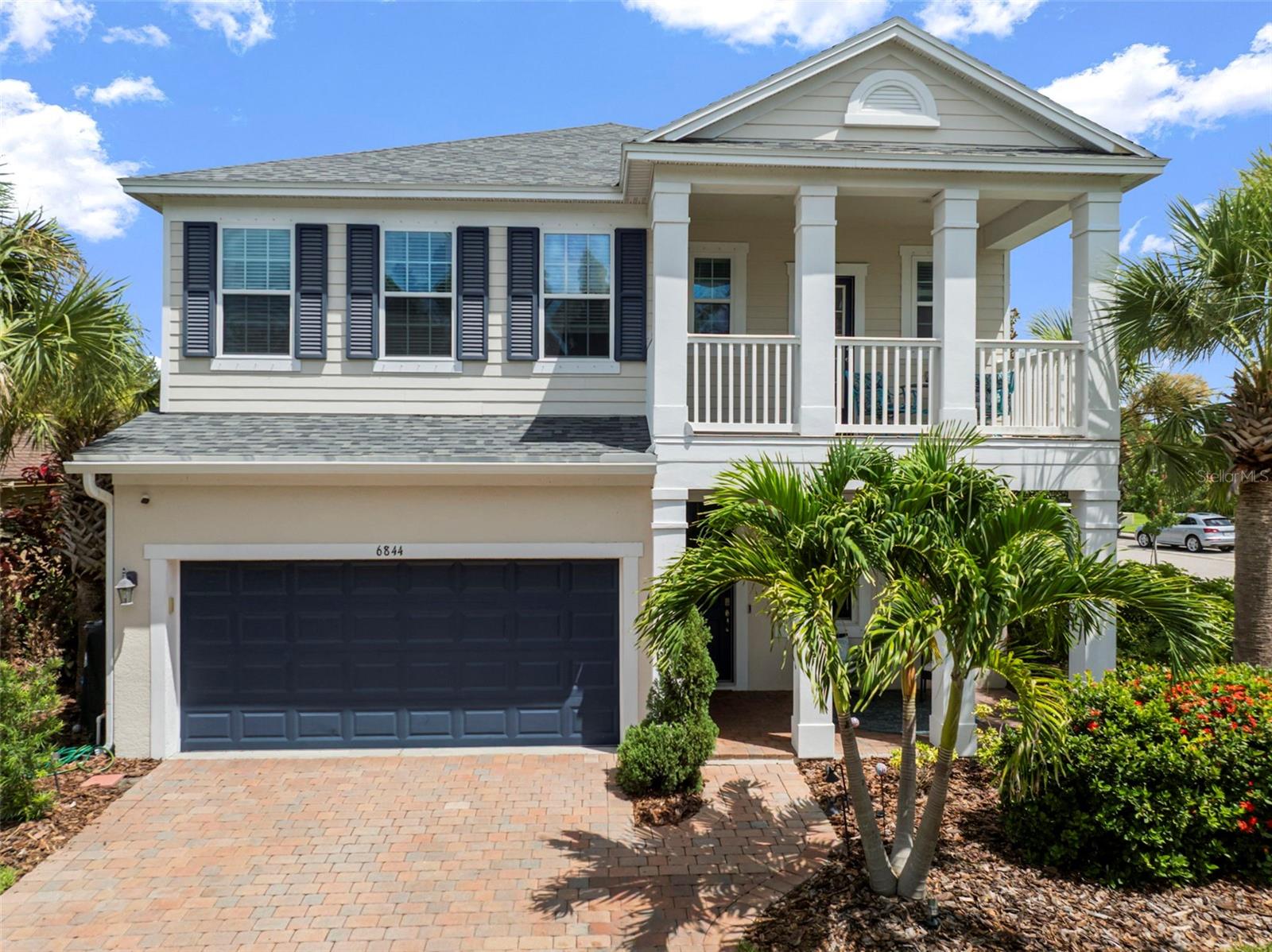 Introducing a rare opportunity to own the very first homesite released in Waterset, a beautifully designed Ashton Woods Jannus model on a prime corner lot with no front neighbors and serene pond views. This 4-bedroom, 2.5-bathroom home is an entertainer's dream with an oversized yard and a heated saltwater pool, perfect for gatherings year-round. From the upstairs balcony, large windows, and welcoming front porch, you'll enjoy breathtaking sunsets and peaceful water views that make every evening feel special. Inside, the home is full of thoughtful design and natural light. The primary bathroom features a massive walk-in shower and clean, modern finishes. Every space is crafted for comfort, style, and function. Just a 2-minute walk brings you to one of Waterset's top amenity hubs with a pool, playground, and fitness center. As part of this vibrant master-planned community, you'll also enjoy access to soon-to-be 6 pools, 2 fitness centers, dog parks, tennis and basketball courts, pickleball, and 12+ miles of scenic walking trails. Waterset is more than a neighborhood, it's a lifestyle. Book your private viewing today!
