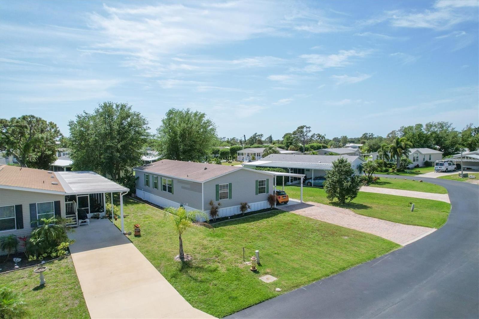 This two bedroom, two bathroom manufactured home in the 55 and over Sandalhaven park has a modern feel with upgraded appliances and nice finishes. Move right in and enjoy the extra space of the den which could be used for a home office, a second living room, or a flexible space of your choice. The kitchen is open to the main living area with cathedral ceilings, perfect for every day living and entertaining. Sandalhaven is a well maintained community that shows pride in ownership. The roof and air conditioner were replaced seven years ago and everything is well maintained and in excellent condition. The $300 quarterly HOA fee includes use of common amenities including a pool, and the deed restrictions ensure the character of the neighborhood remains as it is. Outside you will find a beautiful lawn with a separate well and pump for irrigation (2023). The greater Placida area is a beautiful natural area with far lower population than areas to our north and south. There are many parks, miles of beautiful beaches, golf courses, and county recreation areas to enjoy.