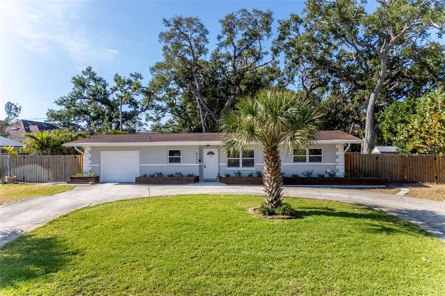 Whether you are looking to start your family's next chapter or simplify into a more manageable lifestyle, this gorgeous 3-bedroom, 2-bathroom gem in Villa Park Estates is the perfect fit! Nestled in the heart of Jungle Terrace, this home offers the ideal blend of modern style and effortless maintenance. The open-concept interior—featuring stunning granite countertops, a breakfast bar, and durable luxury vinyl flooring—is designed for both lively family gatherings and easy, single-level living. With a separate dining room and spacious bedrooms, you won’t have to sacrifice the space you love for the convenience you need. Forget the stress of "fixer-upper" projects and heavy maintenance. This home is built for peace of mind, boasting a brand-new roof (May 2026), hurricane-impact windows, and a circular driveway that makes coming and going a breeze. Step out into your private tropical oasis, where the enclosed porch and fenced backyard offer a peaceful retreat for morning coffee, while providing a secure space where kids and pets can play safely under the sun. This outdoor space is also the ultimate setup for entertaining friends and family in a lush, private setting! For those who value tranquility, you will love the unique positioning of this property: it backs up to a quiet private road serving expansive waterfront estates. With the neighboring home set deep back on its massive lot, you’ll enjoy a rare sense of seclusion and the serene feel of having no rear neighbors. Location is the ultimate luxury here. You are just minutes away from the vibrant energy of downtown St. Pete, the convenience of Tyrone Square Mall, and world-class healthcare. This central location keeps you close to local schools and just a short drive from soaking up the sun at our famous Gulf beaches, ensuring everything you need is right at your fingertips. From young families seeking room to grow to downsizers looking for a stylish, secure "lock-and-leave" lifestyle, this home caters to all. This one will not last long—schedule your private showing today!