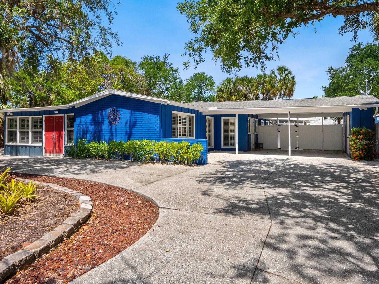 Grab your shades, flip-flops and sunscreen; in just half a mile, you’ll feel powdery white quartz sand in your toes at world-famous Siesta Key Beach, where you’ll be mesmerized by the crystal-clear azure waters of the Gulf of Mexico. Live the island lifestyle you’ve always dreamed of in this three-bedroom, den, two-bath midcentury pool home, centrally located, close to all that living on the island of Siesta Key is about. Sited on a large, nearly 19,000-square-foot fenced corner lot in the popular deed-restricted community of Siesta Isles, this home is a wonderful beach getaway, second home or full-time residence. For investors, this is a desirable investment home by the beach with a current rental history with additional future value as a new homebuilding site! The spacious, open concept floor plan offers flexible use of the large rooms. The living room is bathed in natural light by the wraparound wall of windows. The kitchen is open to the living and dining rooms and features a breakfast bar. The generous master bedroom offers an en-suite bath and French doors that lead to the screened lanai and sparkling pool with a waterfall and paver deck. Two guest bedrooms share a bath, one also has direct pool and screened lanai access. Your favorite place to bathe after a day at the beach will be the outdoor shower! The large, fenced yard is perfect for family and pets, offering plenty of room for play and toys. Bahama shutters throughout. Low-maintenance yard, circular driveway, two-car carport with storage and additional storage shed. Available to be sold with turnkey furnishings. Deed-restricted active community with a voluntary HOA - membership dues only $150 per year. Visit the nearby unique boutiques and restaurants of charming Siesta Village, only 1.5 miles away. And before sunset, head over to see the blazing mango and cotton candy skies Siesta Key Beach is famous for. Just 15 minutes over the Siesta Drive Bridge to downtown Sarasota's urban and cultural amenities, shopping, restaurants and entertainment. Visit the Sarasota Farmers Market, the Ringling Museum, St. Armands Circle for shopping and dining, or just relax on the beach!