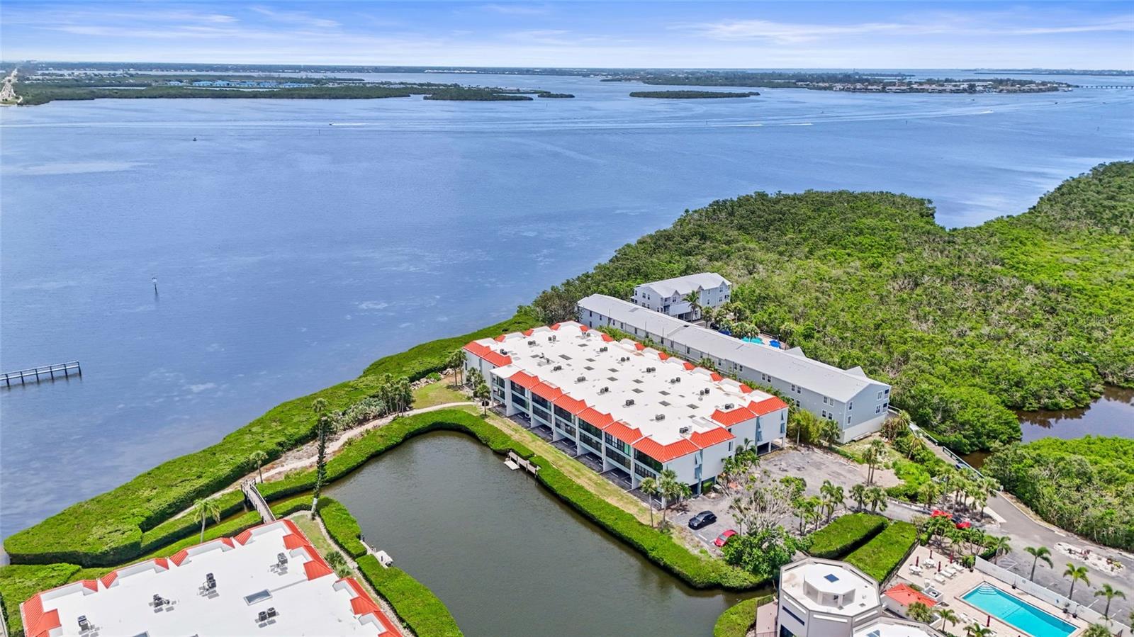 Welcome to coastal living at its finest on Anna Maria Island—where you can get million-dollar waterfront views without the million-dollar price tag. Welcome to Sunbow Bay, where coastal living meets convenience right on Anna Maria Island. Just three blocks from the Gulf’s sugar-white sand and turquoise waters, this beautifully updated 2-bedroom, 2-bathroom condo offers the ultimate island lifestyle. Enjoy the ease of under-building parking and elevator access to your private retreat. Inside, the kitchen shines with quartz countertops, stainless steel appliances including a sleek vent hood, a stylish tile backsplash, and a charming eat-in nook. The open-concept layout connects the kitchen to a spacious living and dining area, perfect for entertaining or relaxing after a beach day. The owner’s suite features direct balcony access through sliding glass doors, a large walk-in closet, and a spa-like ensuite with a glass-enclosed walk-in shower. A split bedroom floorplan provides ideal privacy, with the second bedroom and guest bath thoughtfully tucked away. Step out onto the oversized balcony and soak in panoramic views of the Bay—an everyday reminder you’re living in paradise. Sunbow Bay offers resort-style amenities including two sparkling pools, a fishing pier, tennis court, kayak launch and storage, plus your own storage closet in the garage for all your beach gear. With a new roof in 2024 and a prime location near shops and restaurants, this is the perfect blend of luxury and laid-back island charm. Don’t miss your chance to make it yours—schedule your showing today!