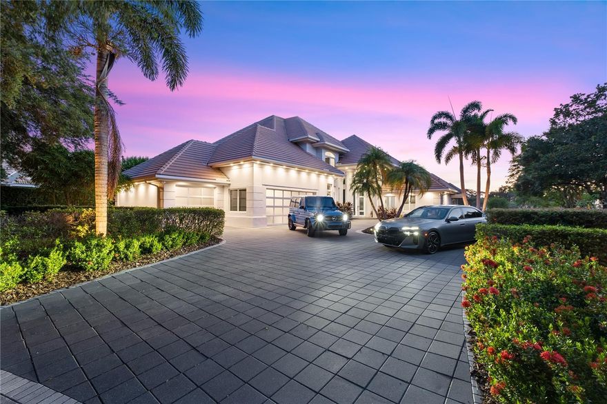 Welcome to 9138 Great Heron Circle, a true masterpiece of architectural excellence nestled in the highly sought-after guard-gated community of Cypress Point in Orlando. Built by esteemed builder Ray Coudriet and designed by architect Tom Price, this custom estate was meticulously crafted to withstand winds up to 145 mph, reflecting the highest standards of quality construction and luxury living. !!! BRAND NEW ROOF !! ( West Lake Concrete Tile Sterling Grey with NEW White 6 inch gutters around the complete home totaling $145,733 completed September 5, 2025). Bathed in natural light from expansive picture windows, the home is perfectly positioned to offer panoramic views of a tranquil pond and the breathtaking sunsets over Lake Sheen, part of the prestigious Butler Chain of Lakes. Inside, modern design meets timeless elegance, beginning with a grand foyer featuring gleaming granite and white-washed bamboo wood floors illuminated by ambient LED cove lighting, and 16 surveillance cameras. The open-concept layout is tailored for both comfort and entertainment, featuring a spacious home theatre and a glass-enclosed home office for privacy and productivity. Ascend the sleek open-air staircase to discover the serene master suite, which offers a peaceful exercise space overlooking the water, a private balcony for morning coffee, and a spa-inspired retreat atmosphere. The gourmet kitchen is a chef’s dream, outfitted with modern European cabinetry, high-end stainless steel appliances including a Sub-Zero refrigerator, and a layout that inspires culinary excellence. A generously sized laundry room includes a utility shower, while a second large home office provides a tranquil and functional workspace. Floor-to-ceiling glass windows frame uninterrupted views of the pond and lake, enhancing the home’s connection to nature. For wine connoisseurs, the 1,100-bottle wine cellar offers both luxury and function, while the resort-style pool with a swim-up bar and a summer kitchen—featuring a striking backlit Aqua Blue Agate surface and automated pool controls—create the ultimate setting for outdoor entertaining. Car enthusiasts will appreciate the climate-controlled garage with space for up to five vehicles, equipped with two hydraulic lifts and glass doors for a sleek, modern look. With every detail carefully considered and top-tier amenities throughout, this home is the pinnacle of refined living. Don’t miss your opportunity to experience the unmatched elegance, comfort, and sophistication of this extraordinary residence. Schedule your private showing today.