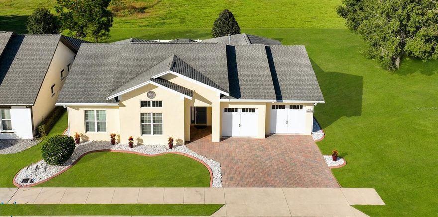 This GORGEOUS, immaculately kept Willow model home in Grand Oaks Manor, Oxford FL, is a
showstopper! Fully furnished (option), offering a unique combination of modern elegance,
comfort and privacy. Don’t miss out on this rarely available Willow model featuring 3
bedrooms/2 bath/oversized 2 car garage with an open split floor plan and SOARING 12’ ceilings.
As you enter the great room you’ll notice the elegant multi-sliding telescoping glass doors with
clear-story windows above which seamlessly expands the interior living area out onto the
expansive lanai. Just beyond the great room is a Chef’s dream kitchen boasting 42” upper
cabinets, beautiful granite countertops with sizeable island, gas range, dishwasher, refrigerator,
microwave, double door pantry and kitchen pass-through window with granite counter - a
perfect serving station and bar for your fun-filled outdoor gatherings on this very private,
spacious outdoor birdcage lanai with privacy screen. Enjoy cozy dinners under the lighted patio
table umbrella or take in a late night-movie on the wall-mounted flat screen TV from the
comfort of the large sectional sofa, surrounded by the ambiance and warmth of the fire pit, or
soak up the rays in the afternoon in your resort-style lounge chairs hidden away from the view
of others by the privacy fence that encloses the large backyard. The primary suite offers a tray
ceiling, huge walk-in closet and ensuite bathroom. The ensuite includes a glass-framed
oversized shower, dual vanities with his and her sinks and a floor to ceiling three-way mirror
and a separate room with toilet. Two spaciously appointed guest bedrooms are located on the
opposite side of the home from the primary suite as well as a floor to ceiling linen closet in the
hall and a private guest bathroom with a shower and tub combination. This home boasts
several upgrades - new kitchen pendant lights, dining and living room chandeliers, brand new
front load washer and dryer, living room Vertiglide blinds, 6” baseboards, 8’ solid wood interior
doors with oversized 4” door casings, barn-style doors, custom interior paint, a massive stand
up attic with plywood flooring accessible from the oversized 2-car garage, leaf guard protection
seamless gutters, concrete flower bed curbing and white marble rock beds, brand new sprinkler
system, and a state of the art builder-installed camera security system with upgraded smart
camera night vision technology, guarding the entire home perimeter, lanai and front door,
includes intrusion sensors on all doors and windows as well as glass break sensors with
intrusion and fire alert monitoring. Whether you travel, are snowbirds or just want the best
home protection for your family, this security system provides complete peace of mind.
Conveniently located just minutes from The Villages, The Villages Charter School, and a myriad
of dining, shopping and cultural events. The incredibly appointed Clubhouse offers event space
for parties, weddings and family gatherings as well as a pool, hot tub and fitness center. There’s
a dog park for your furry friends and a playground for the little ones as well as walking trails and
pickle ball courts.