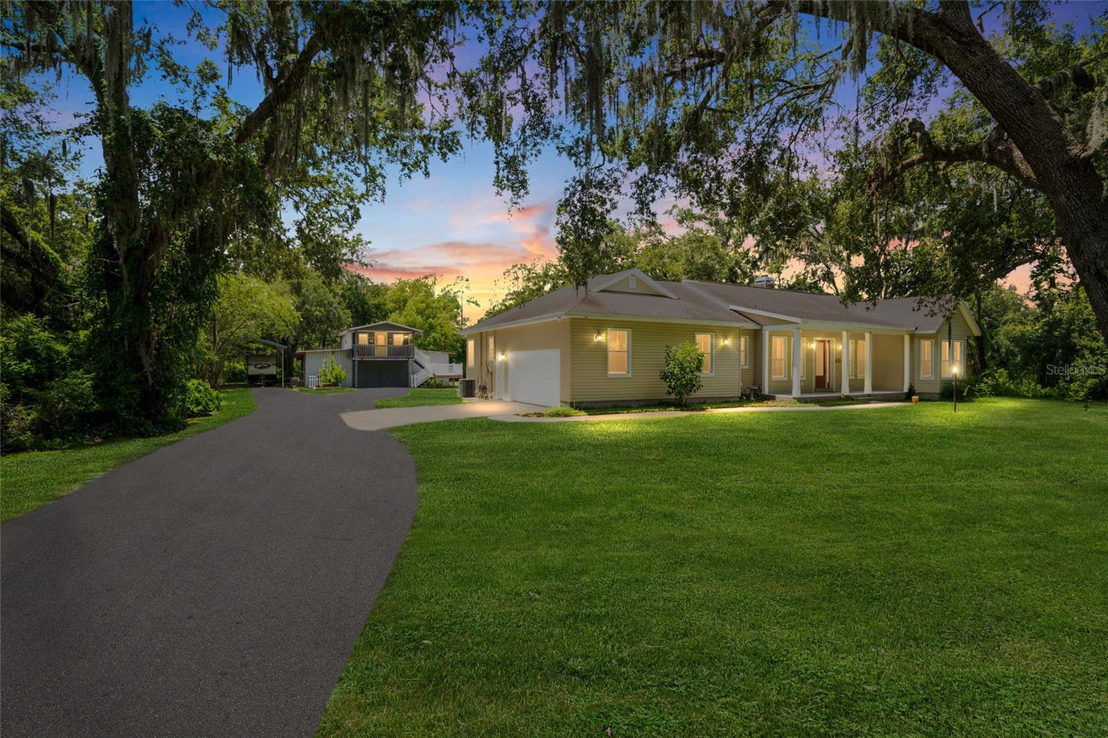 Welcome to your slice of heaven among the strawberry fields—this 3.41-acre Plant City estate offers the perfect blend of peaceful country living and modern convenience. A charming, picturesque oak-lined driveway sets the tone as you enter a property brimming with potential. The main home, built in 2006, features 3 bedrooms, 2.5 bathrooms, and 1,855 square feet of heated living space. Its thoughtful split floor plan creates privacy while the open-concept layout connects the foyer, living room, dining area, and kitchen into one cohesive and inviting space. Throughout the home, durable wood-look tile flooring provides a seamless, polished finish that enhances both style and functionality. A spacious two-car garage adds to the practicality, offering room for storage or hobbies.
Beyond the main house, the opportunities are endless. The front portion of the property is zoned agricultural, making it ideal for small-scale farming, livestock, or simply enjoying the land. A detached barn with a fully renovated one-bedroom, one-bathroom apartment above it—updated in 2021 with new AC, electrical, plumbing, drywall, kitchen, bathroom, and flooring—creates a perfect space for guests, family, or even rental income. An RV port with a 30-amp electric hookup, RV sewer, and metal cover was added in 2023, along with a metal pole barn for additional covered parking and equipment storage.
This property offers a rare mix of comfort, flexibility, and freedom, all with no HOA. Whether you're looking for a peaceful homestead, space for recreational vehicles and outdoor toys, or a multi-generational living setup, this estate can accommodate your lifestyle.
The location is just as appealing as the property itself. Nestled in the heart of North Plant City—widely known for its vibrant agricultural roots and small-town charm—you’ll be minutes from the world-famous Florida Strawberry Festival, as well as locally loved spots like Keel & Curley Winery, Parkesdale Farm Market, and Dinosaur World. Nature lovers will appreciate nearby Edward Medard Conservation Park, offering fishing, hiking, and horseback riding. Plus, with quick access to I-4, you’re perfectly positioned between Tampa and Lakeland, making commuting or day trips a breeze. This is more than just a home—it’s a peaceful, grounded lifestyle with the freedom to grow, create, and enjoy everything Florida’s countryside has to offer.
