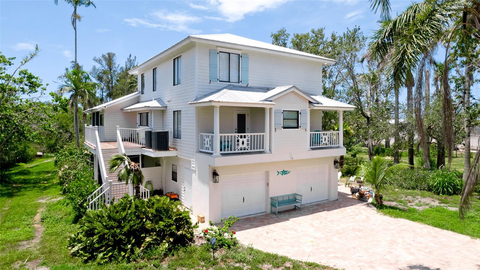 Looking for the perfect property to build a boat dock on Palma Sola Bay? There is a Coastal charm in this waterfront home! Tucked along the shores of Palma Sola Bay, this beautiful residence offers sweeping water views, custom finishes, and versatile living spaces — including a private Airbnb-ready suite on the first floor with a strong rental history! Upstairs, the heart of the home features a gourmet kitchen with custom cabinetry, thick granite countertops, pot filler and center island. Entertain in the open-concept living area or unwind on the second-floor lanai with Palma Sola Bay views. Also on this level, each bedroom includes an en-suite bathroom and private porch, offering ideal accommodation for guests. The luxurious primary suite is a retreat with elegant tray ceilings, coffee bar, huge walk-in closet, and spa-inspired bathroom complete with a freestanding tub, double vanity, and separate glass shower. Additional highlights include a spacious walk-in laundry room. Step into the backyard and onto your private kayak dock — perfect for fishing, kayaking, or paddle boarding in the serene bay waters. Whether you are seeking a luxurious primary residence, a multi-generational home, or a profitable rental opportunity, this Palma Sola Bay gem checks every box. Outdoor living is just as impressive, with storage space for yard tools and pool gear right off the lanai. Extras include fire pit, metal roof car port, and planation shutters throughout.