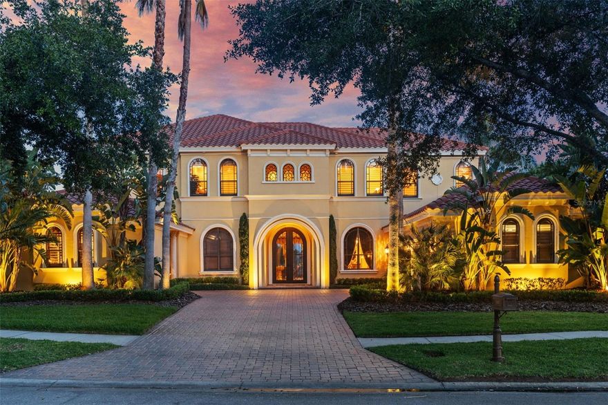 Tucked away in the exclusive gated cul-de-sac of Mar Azul - Waterchase’s most exclusive gated enclave - this extraordinary custom-built estate offers a rare opportunity to own a piece of true Florida luxury. With stunning water views, this meticulously maintained residence impresses with its timeless architectural design, impeccable craftsmanship, refined finishes, and resort-style amenities - 11817 Glen Wessex Court is designed for those who seek both elegance and comfort in a private, elite and serene setting. From the moment you arrive, through the custom steel and glass double front entry doors into the grand foyer, you’ll be struck by the panoramic water view that sets the tone for the entire home - only to be outdone by the custom, climate-controlled 1,600-bottle wine cellar and designed for the connoisseur as a true showpiece of sophistication, function and dramatic visual appeal. The outdoor living experience is nothing short of spectacular. Enjoy complete privacy in the stunning two-story screened lanai that maximizes your enjoyment of the tranquil water views year-round. Cedar plank ceilings frame multiple covered dining and lounging spaces, perfect for enjoying a morning coffee or evening beverage while relaxing listening to birdsong, watching deer and ducklings delight. Entertain with ease in the full outdoor kitchen, featuring a built-in gas pizza oven, grill, fireplace and beverage center, all steps from the sparkling pool and spa. This backyard oasis is perfectly designed for year-round enjoyment, seamlessly integrating with the home’s indoor spaces through expansive sliding doors and thoughtful architectural design.
Inside, every detail reflects timeless elegance and high-end craftsmanship. The gourmet kitchen boasts custom-built solid wood cabinetry, premium Wolf and Sub-Zero appliances offering both beauty and performance, practical buffet area, Butler’s pantry and dining nook, creating a true culinary centerpiece perfect for large gatherings or relaxed family dinner in the large dinette, capable of comforatbly accommodating a 72" table and 8 chairs. The home’s imported mud-set travertine floors bring a rich warmth and sophistication, gas fireplaces add cozy ambiance, and the large sliders create the opportunity for a seamless indoor/outdoor lifestyle. With a total of 6 spacious bedrooms, two being expansive main-floor master suites and one a separate private suite which is ideal for a nanny, au pair, or multigenerational living, the home offers exceptional flexibility. The oversized furnished media and game room is ideal for entertaining, while a separate large bonus room provides space for a home gym, playroom, or additional lounge.
Additional features include: 24kW whole-house GENERATOR 2021, pool pump & salt cell 2023, three Lennox Signature AC units (serviced annually), TILE ROOF in immaculate condition - cleaned every two years, with 4 point. Water softener 2023, water heater 2017.  Waterchase offers unparalleled amenities: a resort-style pool with waterslide, tennis and pickleball courts, fitness center clubhouse, playgrounds, walking paths, and a vibrant social calendar - all within a 24/7 guard-gated community. Homes of this caliber in Mar Azul rarely come to market and this is not just a home - it’s a lifestyle of luxury, privacy, and distinction.