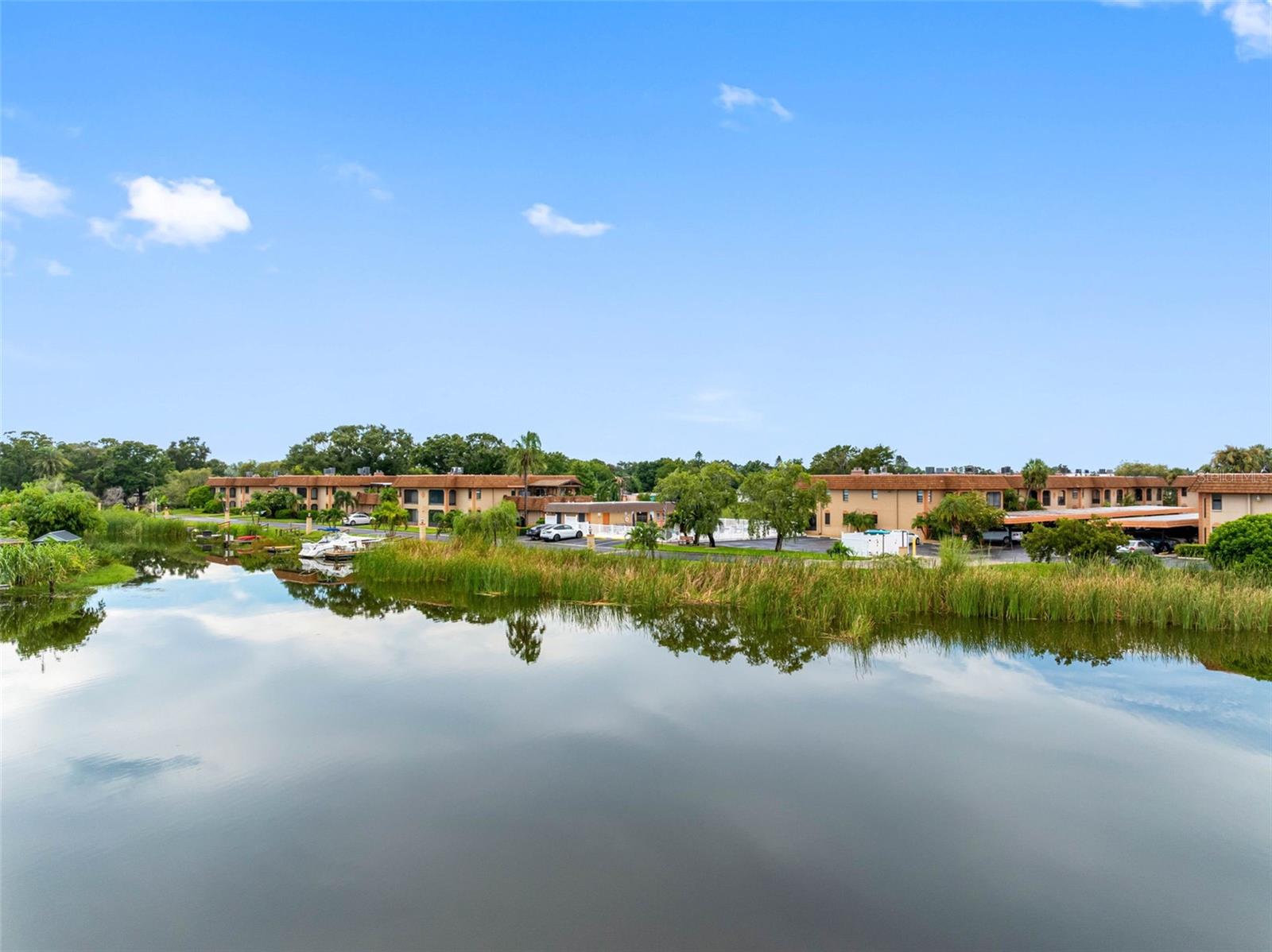 One or more photo(s) has been virtually staged. RARE ROOFTOP PATIO | DOCK WITH DESIGNATED SLIP | RESORT-STYLE POOL | ONE CAR GARAGE | NO FLOOD INSURANCE REQUIRED FOR MORTGAGE.
Be sure to check our video tour link! Call to see today!
RARE OPPORTUNITY on LAKE SEMINOLE! This beautifully updated 2 Bedroom, 2 Bath townhome-style residence in a desirable GATED COMMUNITY offers the ultimate Florida lifestyle with THREE PRIVATE PATIOS, including a RARE LARGE ROOFTOP PATIO with panoramic lake views. The owner has made thoughtful updates including modern vinyl flooring, upgraded granite countertops, sleek stainless steel appliances, and a striking stacked stone fireplace with an electric insert for ease of use. Maintained with care and truly move-in ready, this home combines comfort and style with everyday convenience. Boating and fishing enthusiasts will love the SHARED DOCK WITH A DESIGNATED SLIP for direct access to Lake Seminole, while the community’s RESORT-STYLE POOL provides the perfect place to relax and unwind. Additional highlights include a ONE CAR GARAGE, in-unit WASHER/DRYER, and an open, light-filled layout. The HOA covers exterior maintenance, water/sewer, and gated security, making for easy, low-maintenance living. While the community itself is partially in a flood zone, this specific property is located in FLOOD ZONE X and is TWO STORIES, meaning NO FLOOD INSURANCE IS REQUIRED FOR MORTGAGES—a huge savings and peace of mind. Conveniently located with easy access to Gulf beaches, shopping, dining, and major highways, this property offers the very best of Florida living. Welcome Home! Don’t miss this opportunity.