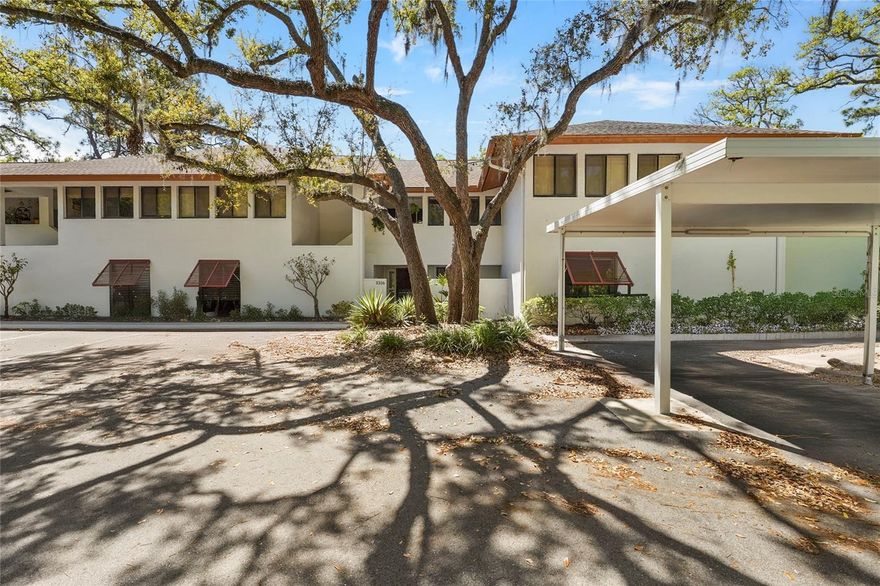 Welcome to this beautifully updated ground-floor condo in the quiet, wooded community of Crooked Creek—locally referred to as “the hidden gem” of Sarasota. Surrounded by the 72-acre Red Bug Slough nature preserve, with private community access, this 2-bedroom, 2-bath residence offers the perfect blend of serenity and convenience, just minutes from everything Sarasota has to offer.

Crooked Creek’s original two buildings, designed by Sarasota School of Architecture Modernist master architect Tim Siebert, FAIA, are constructed of CMU with stucco and reflect the clean, timeless lines of this iconic design movement.

Inside, the home showcases a contemporary coastal aesthetic filled with natural light and thoughtful design. Hardwood floors flow throughout the main living spaces, complemented by stone flooring, built-ins, detailed molding, and plantation shutters, creating a refined and cohesive look.

Four sets of French doors open to a stone-floored Florida room, allowing sunlight to pour into the home while offering peaceful views of the surrounding wooded landscape. Just off the kitchen, a private patio provides an additional outdoor space ideal for morning coffee or quiet relaxation.

The kitchen features a recessed ceiling, granite countertops, stainless steel appliances, and a stone backsplash—blending both style and functionality.

The spacious primary suite easily accommodates a sitting area or workspace and includes a beautifully appointed ensuite bath with double vanity sinks, stone basins and backsplash,  tiled walls and floors, and a soaking tub with an overhead rainfall shower.

The great room offers custom built-in shelving and a cozy electric fireplace, creating a warm and inviting space for relaxing or entertaining. This home also includes a security system for added peace of mind.

Residents enjoy a range of community amenities including a pool, pool house with kitchen, gazebo, grills, tennis and pickleball courts, carport, storage room, and charming pedestrian bridge—all set within a lush, park-like environment.

Located in a peaceful natural environment yet just minutes from world-renowned Siesta Key Beach, as well as shopping, dining, and entertainment, this Crooked Creek condo delivers the very best of Sarasota living.