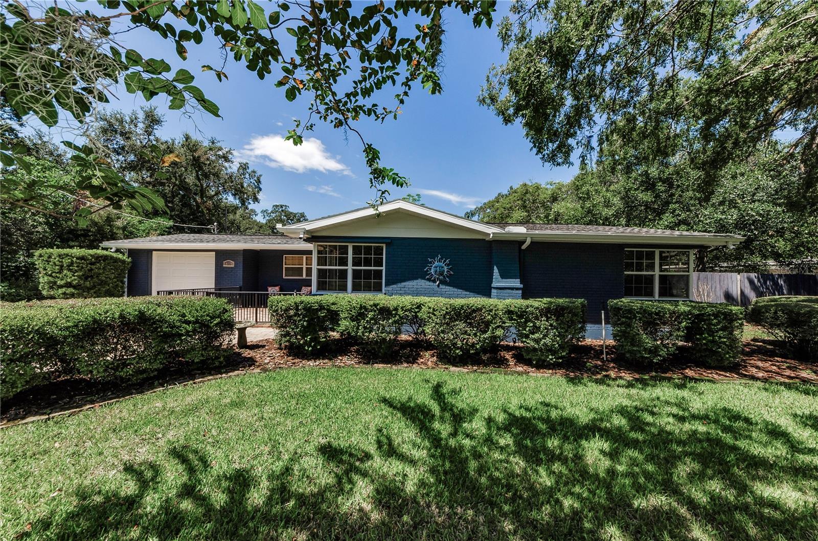 EXCITING, AMAZING !! Those are only two of many words that describe this special home in the heart of the Forest Hills/Carrollwood area. Let me ask, do you own an RV or are you a car collector, or maybe you just like to enjoy and work on all your automotive "toys". If so, this property is for you. Tucked behind this lovely home with a private gate is an expansive carport that was meticulously built and can house your RV and multiple vehicles. But wait there is more. Also included are two airconditioned private rooms with vaulted ceilings that are perfect offices if you work from home, or a man cave and a she cave! Between the two rooms there is an additional 342 square feet of air conditioned space.
Well now let's move on to the main home featuring 3 Bedrooms, 2 baths, large great room, dining space and a Florida room. Also included is a large utility room with laundry tub and upper cabinets AND an extra refrigerator. This wonderful room is located behind the home's one car garage and is part of the central air system.
Let's talk about the rest of the house. You enter the front door though a charming paved courtyard and walk into a light and bright Great room with corner windows and a lovely fireplace. The kitchen is open and features beautiful refinished cabinets, new stainless farm sink, new back splash and of course new quartz counters. The island is large with extra storage and great for entertaining. The dining area is open to the kitchen and creates a great flow to enjoy family and friends. Off the kitchen is a Florida room that leads out to the 9 ft by 34 ft screened lanai. Then the lanai opens to an outdoor patio, all looking over the expansive back yard with new lush landscaping and lighting. Moving back inside behind all of the gathering areas you are treated to the Master bedroom with walk in custom closet and private master bath with walk in shower. The hall bathroom services bedrooms 2 and 3 and both bathrooms have new Kohler toilets. The hallways are wide and lead to the two ample sized bedrooms. Other great features are the hardwood floors throughout, recessed lighting, high baseboards, and new ceiling fans with lights plus a new disposal and water heater. Topping everything off, this home has been painted inside and out, all landscaping is new and the lot is immense 120 x 130 and looks across to the Forest Hills Golf Course. THIS HOME IS JUST PLAIN SPECAIL waiting for a new family to enjoy!! It truly is AMAZING AND EXCITING!!