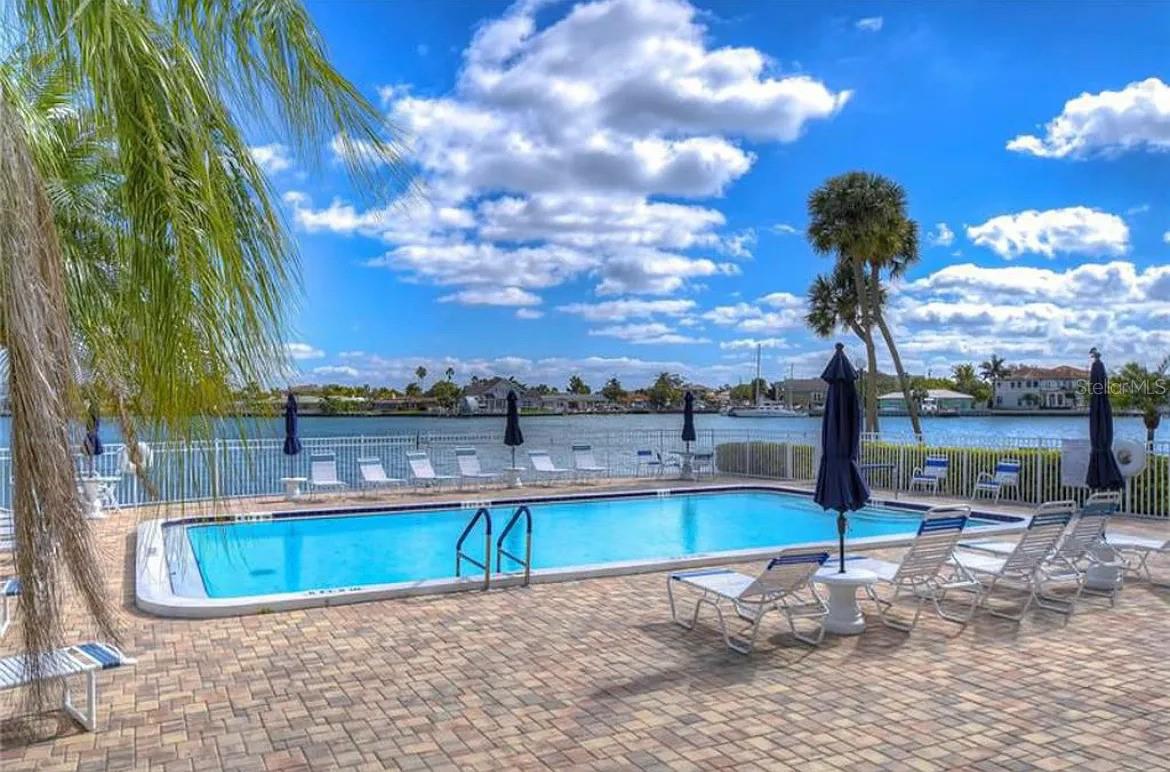 Enjoy the Florida lifestyle in this bright and spacious 1-bedroom, 1.5-bath condo located in the highly sought-after gated community of Three Palms Pointe in St. Pete Beach. Just a short walk to the sand and surf, this beautifully maintained unit offers an open-concept living and dining area with plenty of natural light, an updated kitchen with ample cabinet space and a full appliance package, and a large primary suite featuring a walk-in closet and a full private bath. Step outside to your private balcony—perfect for morning coffee or evening sunsets. The community features resort-style amenities including a heated waterfront pool, fitness center, sauna, clubhouse, fishing dock, kayak launch and storage, shuffleboard courts, and secure gated access. HOA fees include water, sewer, trash, internet, cable, and assigned parking, with plenty of guest parking available. Located close to shops, restaurants, and everyday conveniences, this is the ideal home for anyone seeking low-maintenance coastal living in a pet-free, smoke-free building. HOA approval is required for all buyers—schedule your private showing today!