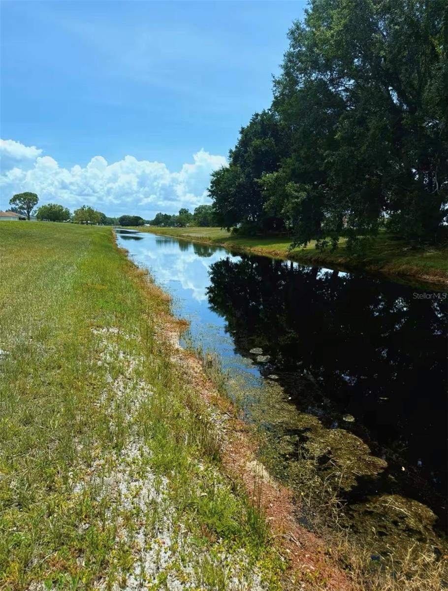 This HIGH and DRY .53-acre residential lot sits on a peaceful CANAL in the desirable Spring Lake community. With a completed survey, nearby electrical access, and paved road frontage, this property is ready for your new home or investment project. The lot offers serene water views and convenient access to nearby amenities, all within a well-established neighborhood known for its quiet charm and natural beauty. Spring Lake is home to the Sebring International Raceway, a world-renowned motorsports destination that hosts the annual 12 Hours of Sebring endurance race. The area also offers the Spring Lake Golf Resort and numerous freshwater lakes, ideal for outdoor recreation. A standout feature of the community is the Spring Lake Eco Park, which includes shelters, picnic tables, grills, and benches for relaxing afternoons. A 1.47-mile walking and biking trail winds through the park, attracting residents and guests alike. There is also a dedicated Bark Park, offering a safe and enjoyable space for dogs to run and play. This location provides a great balance of seclusion and convenience. It is approximately 45 minutes from Lake Placid and Highlands Hammock State Park, about 1 hour and 45 minutes from both Fort Myers Beach and Vero Beach, 2 hours from Orlando International Airport, and 1 hour and 30 minutes from Sarasota-Bradenton International Airport. Whether you're planning to build now or hold as an investment, this canal-front lot in a growing community is a rare find.