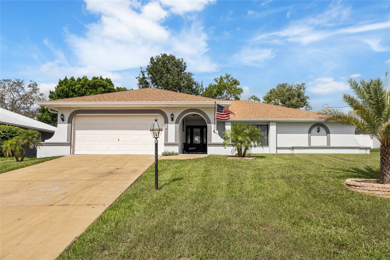 Fully updated, beautifully designed, and move-in ready—this one has it all! Enjoy peace of mind with a 2020 roof, 2022 HVAC, and no HOA or CDD, making it part of a rare find where comfort, style, and flexibility meet. From the moment of arrival, the home impresses with a remodeled entryway featuring fresh exterior paint, custom tilework, and a wide front door that sets the tone for what’s inside. Step into a bright, open-concept layout with a spacious living and dining area, perfect for everyday living or entertaining. The modern kitchen is a true highlight, showcasing granite countertops, ample cabinetry, and a large island ideal for casual meals or gathering with guests. Connected directly to the kitchen is a generous family room with flexible space for a breakfast nook or cozy lounge area. This space features a beautifully designed electric fireplace with a sleek, modern look, set into a striking floor-to-ceiling porcelain stone wall with a built-in TV niche—a true statement piece that adds luxury and warmth to the room. A sliding pocket door here disappears behind the wall, opening fully to the covered and screened patio—a perfect outdoor extension of the living space, ideal for entertaining in total comfort. The split-bedroom floorplan provides privacy, with the primary suite situated on one side of the home. This spacious retreat includes an ensuite bathroom with dual granite vanities, a dedicated vanity area, and another sliding pocket door that opens completely to the patio—offering a seamless indoor-outdoor connection. Two additional well-sized bedrooms and a second full bathroom are located on the opposite side of the home, perfect for family or guests. The screened-in outdoor area is the ultimate entertaining space—covered, private, and built for relaxation. Whether hosting friends or enjoying quiet mornings, this outdoor living area completes the home’s ideal layout. Don’t miss the opportunity to own a home that blends thoughtful upgrades with functional design—this one stands out from the rest!