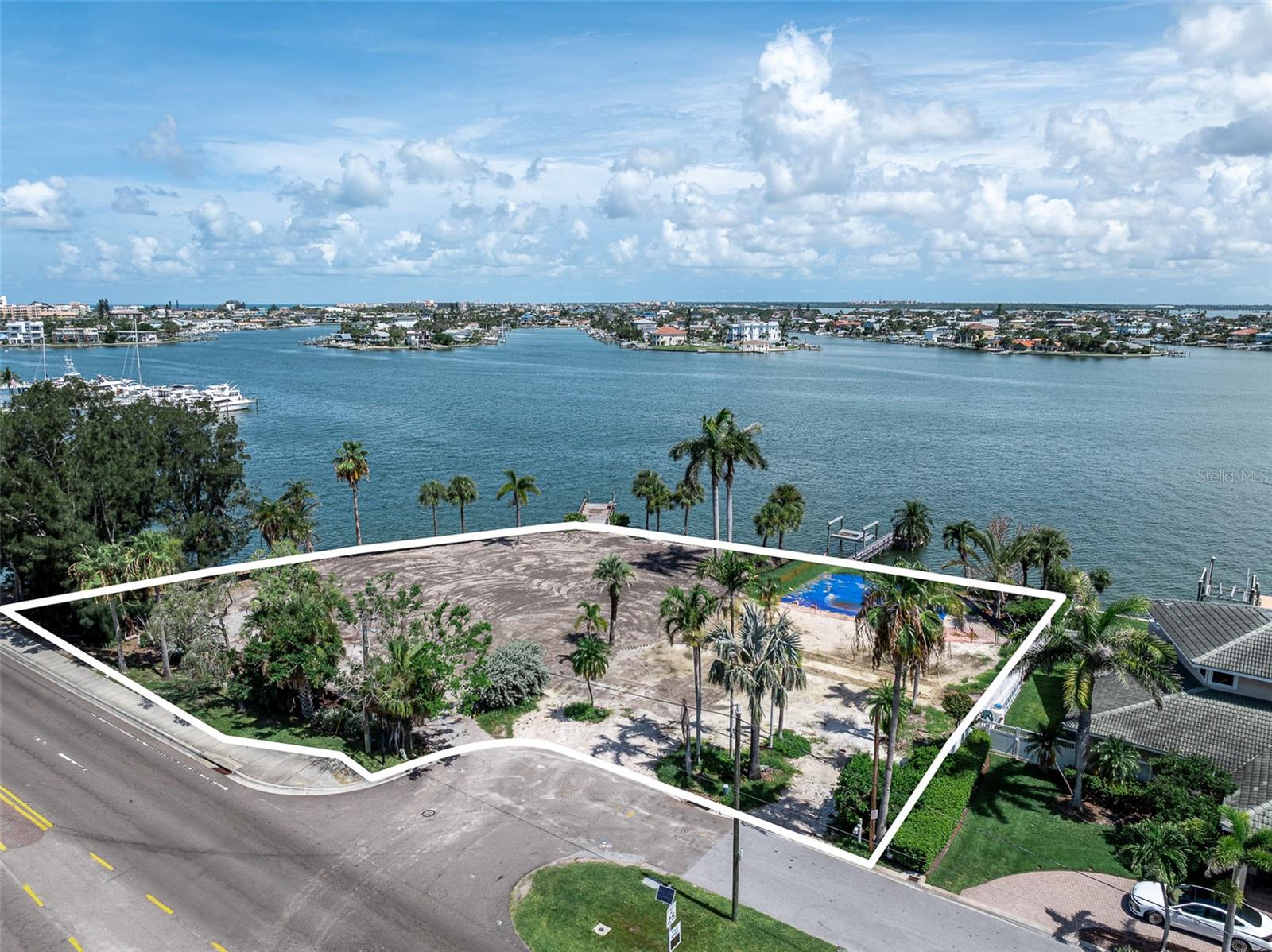 Boater’s Paradise on Treasure Island – Rare Double Waterfront Lot. Discover an extraordinary opportunity to build your dream coastal estate on one of the largest waterfront parcels available on Treasure Island. This rare double lot spans over 2/3 of an acre with over 300 feet of seawall and breathtaking panoramic views of Boca Ciega Bay. With two docks and plenty of room for multiple vessels, this property is a true haven for boating enthusiasts—just minutes to the open Gulf via John’s Pass. Enjoy glorious sunsets over the water, framed by preserved Royal Palms and mature tropical landscaping. An existing deep pool awaits restoration, offering an ideal setting for outdoor living and entertaining. The location is as convenient as it is beautiful—less than a mile to the beach, Publix, local dining, and everyday essentials. Direct access to the Pinellas Trail via bike and a short drive to vibrant Downtown St. Pete. A current survey is available. Don't miss this once-in-a-generation chance to create something spectacular on one of Treasure Island’s most coveted waterfront lots. Call today for more details or to walk the property.