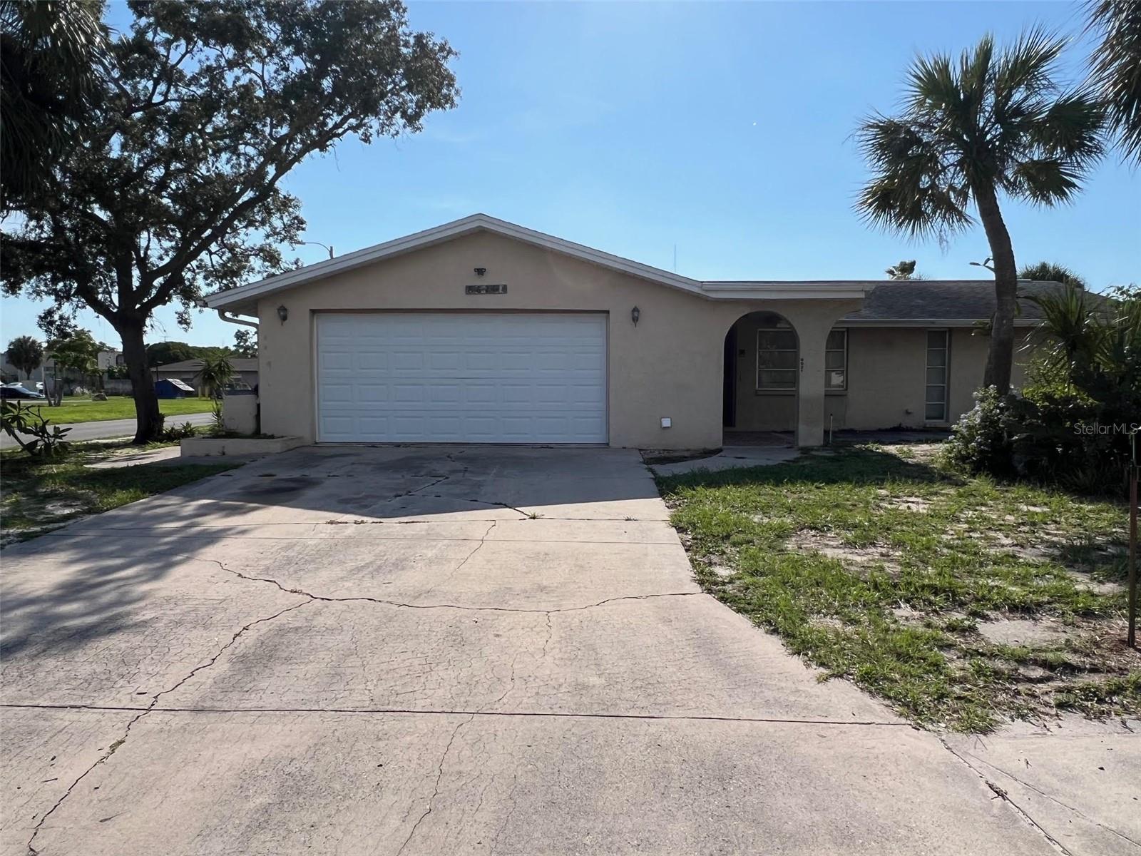 This well-built 1974 concrete block home offers 1,252 square feet of versatile living space and is situated on a generously sized corner lot. Countless advantages come with purchasing this property such as being situated near a variety of shopping opportunities, located in a no-flood zone and having no HOA fees to pay. This two-bedroom, two-bathroom, residence incorporates an open layout, a newer AC system(2021),washer/dryer hookups and freshly painted drywall that offers a blank canvas to add your personal touch. The kitchen seamlessly connects to a welcoming dining area, while the expansive living room can be designed for casual get-togethers or everyday enjoyment. Adjacent to the living room is a flexible bonus space—perfect for a home office, exercise room, study, or even an enclosed porch to extend your living area. This space continues to yet another substantially sized Florida room. Notable interior features include ceiling fans, carpeting, ceramic tile in the kitchen and bathrooms, mini blinds, and ceiling-to-floor windows in the primary bedroom while the guest room is eagerly awaiting the perfect makeover, ready to warmly welcome friends and family. The main bathroom features a shower and tub combination, while the second bath, located in the garage, includes an accessible walk-in shower. With 294 square feet, the Florida room at the rear lends itself to a range of uses, from morning coffee to creative projects or peaceful downtime. The attached garage accommodates two vehicles, with additional parking in the rear available for more vehicles, an RV, or a boat!
With endless potential and a welcoming layout, this charming home is ready to be transformed into your dream space. Don’t miss out—come explore the possibilities today!