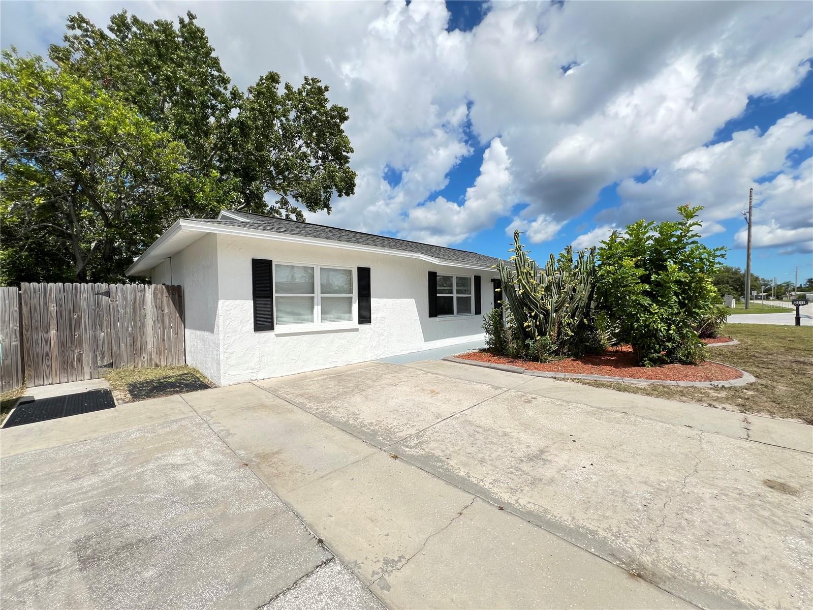 Discover comfort and convenience in this beautifully updated 3-bedroom, 2-bath home tucked away in Holiday, FL. A new roof (June 2025), and new central HVAC system, 2020 water heater, fresh exterior paint, and updated kitchen and bathroom create an inviting, “turn-key” living environment. The home boasts brand-new appliances and energy-conscious comfort with remote-controlled ceiling fans in every room.
The spacious screened-in back patio offers a serene spot for morning coffee or evening gatherings in the Florida breeze. This property presents tremendous flexibility—perfect for personal use or as a solid investment opportunity, with no HOA restrictions. Make your move with peace-of-mind and style!