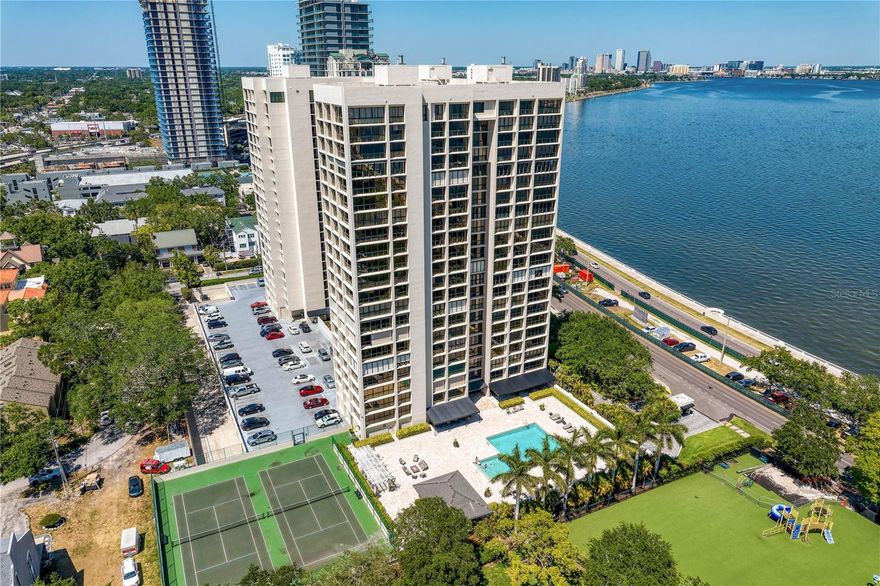 JUST LISTED for RENT - UNFURNISHED - Welcome to the pinnacle of luxury living on the iconic Bayshore Boulevard! Balcony Unit designed by renowned interior designer Tommy Lamb, this extraordinary sky-high residence spans over 4,100 SF on the 22nd floor, offering unobstructed, panoramic views of Tampa Bay, Hillsborough Bay, and Downtown Tampa. This fully customized 4 bedroom, 4.5 bath home seamlessly combines two units into one breathtaking masterpiece where no detail has been overlooked. Step off the elevator into your private foyer and experience rich wood floors with porcelain tile inlay, setting the tone for the exceptional craftsmanship throughout. The expansive living space features floor-to-ceiling windows, a custom wet bar, and sweeping views—perfect for entertaining. The chef’s kitchen is a showstopper, featuring Italian cabinetry, a 96-bottle wine display, walk-in pantry with prep sink, and premium Wolf and Sub-Zero appliances. A hidden butler’s pantry, two wet bars, and a formal dining room that comfortably seats 12 elevate your hosting game. The luxurious primary suite includes a private balcony, spa-inspired bath, and a massive custom closet with water views. All guest suites offer en-suite baths and stunning vistas. Additional features include smart home automation, custom lighting, electronic roller shades, vanity mirror TV, and bespoke closets throughout. Enjoy the convenience of 3 dedicated parking spaces, a private storage unit, and a climate-controlled storage cage. Monte Carlo Towers offers resort style amenities: a 24,000 SF marble lobby, 24-hour concierge, two guest suites, heated pool, grilling area, social room with commercial kitchen, library, fitness center with saunas, and tennis/pickleball courts. Located in a top-rated school district and just minutes to Downtown, Hyde Park, SOHO, Riverwalk, and Tampa International/St. Pete Clearwater Airports, easy access to major highways, including I-275, I-4, and the Selmon Expressway with the nation’s longest continuous sidewalk right outside your door. Experience elevated living at its best—schedule your private tour today!