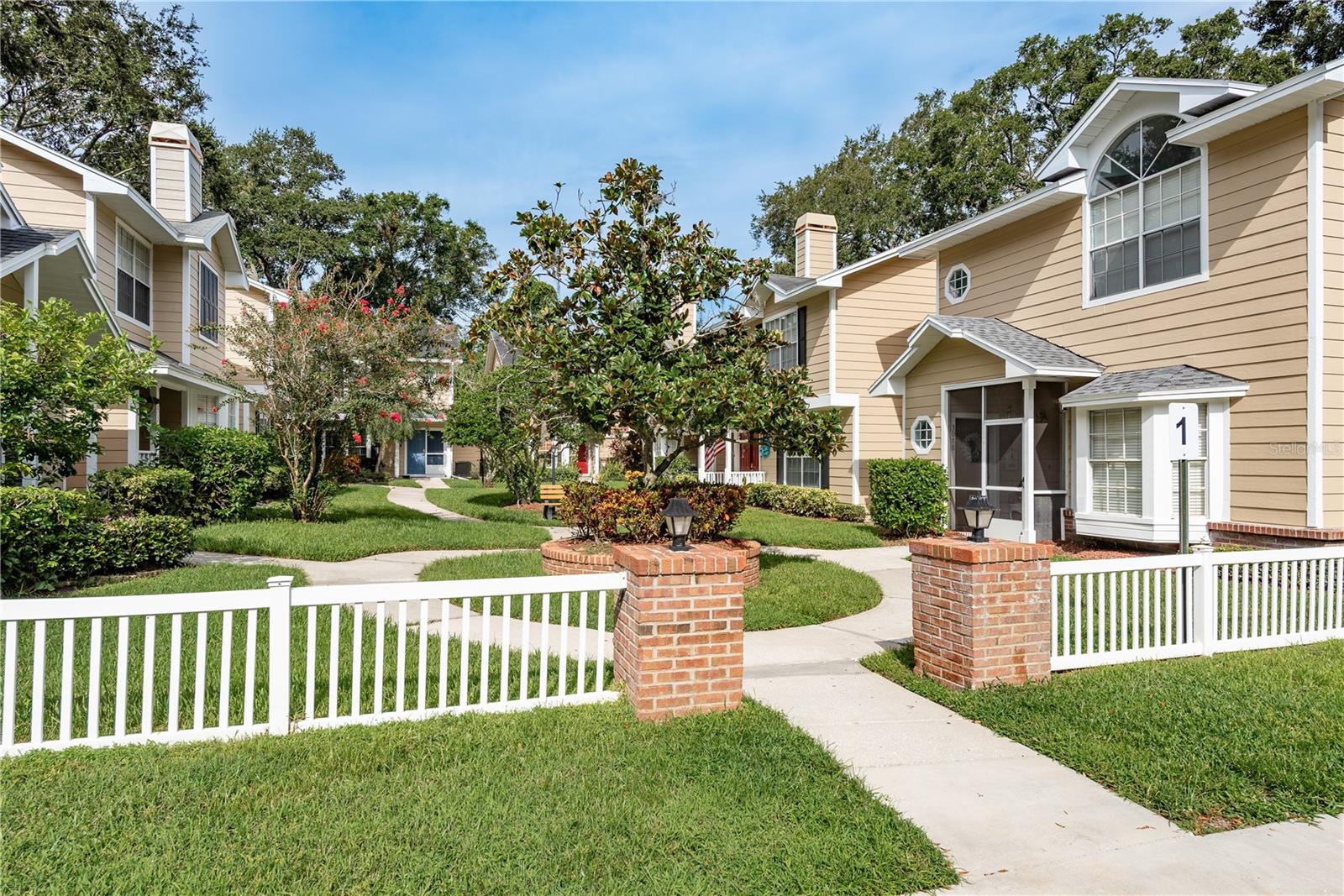 One or more photo(s) has been virtually staged. This Enchanting Villa community in Palm Harbor now offers your next home! The only unit available in Fox Chase townhomes/Villas right now! This adorable 1 story Villa is situated in the back of the courtyard and features a prime location for access to the community amenities! Featuring soaring vaulted Living and Dining ceilings with architectural half moon sunburst window for optimum natural light! The Kitchen is updated and has an abundance of cabinet space including a large corner lazy Susan rack. The Breakfast Bar is large and can also be used as additional space for gatherings as it can easily be incorporated into the Open Layout. The Living and Dining area overlooks the large Lanai and can be designed with your lifestyle in mind! There is Tile throughout the home. The Primary Bedroom has an En Suite Bathroom which has been updated and features dual Vessel sinks and a large fully tiled Step In shower. The Secondary Bedroom features a lovely accent wall and is close to the Main Bathroom which has also been updated. The large Lanai has plenty of room for your outdoor furniture and has nice Patio Roller Shades on each section to adjust based on your preferences. This End unit corner Villa enjoys a private back yard and is situated on a large side yard that is a short walk to the Pool, Courts, etc. The HOA fee covers Water / Trash / Cable / Internet / exterior paint / grounds maintenance / recreational facilities. This is a great opportunity to own in Palm Harbor at an affordable price! Schedule your appointment soon!
