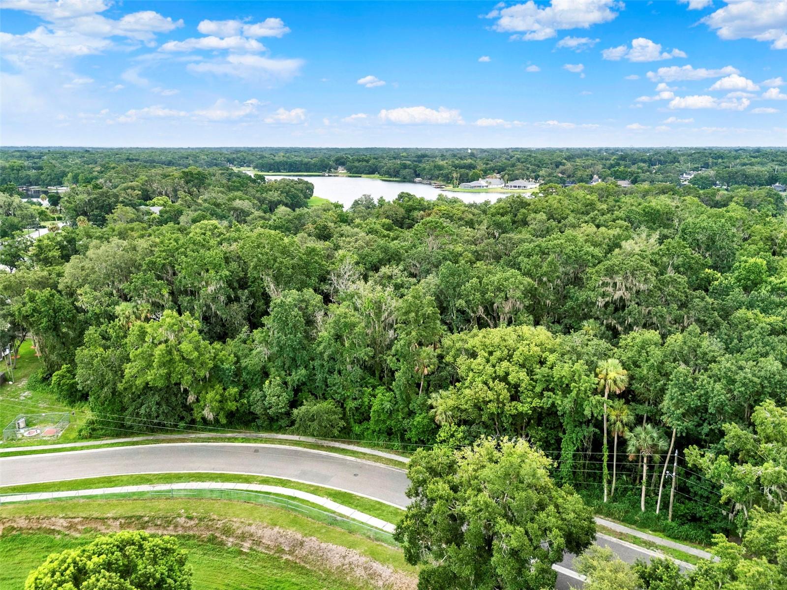 Rare opportunity to own 6.44 acres of prime residential land in the heart of Apopka, with approximately 6.17 acres of high and dry, buildable land. Zoned RMF (Residential Multi-Family), this exceptional parcel offers a wide range of development possibilities—from townhomes to multi-unit residences—or the perfect canvas to build your dream home with plenty of space and privacy. Nestled at the end of a quiet residential street and surrounded by established neighborhoods, this expansive lot provides a natural, wooded setting while remaining conveniently close to major roadways, shopping, dining, schools, and parks. With public utilities nearby and easy access via Lake McCoy Drive, this is a rare infill development opportunity in a growing area with strong demand for housing. Whether you're a developer or someone seeking a private estate-sized homesite, this property offers endless potential in a desirable location.