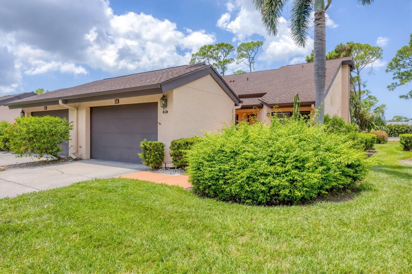 Welcome to this rarely available end-unit villa in the highly sought after maintenance-free community of Woodland Green. Located near University Town Center and the world-renowned Benderson Park - home to international rowing championships and training grounds for the U.S. rowing team. This spacious 2-bedroom, 2-bathroom home includes an over-sized one car garage, and also features a versatile den that can easily be converted into a third bedroom, a home office, or creative space. With a split floorplan, vaulted ceilings, and an open layout, the residence offers an airy, light-filled ambiance perfect for modern Florida living. The spacious kitchen is a chef's delight, complete with granite countertops, a large island, stainless steel appliances and a cozy breakfast nook. The primary suite features a gorgeous golf-course view and built-in shelving in the walk-in closet. The indoor laundry room adds to everyday ease. Step into the enclosed Florida room and take in expansive golf course views - your private vantage point to enjoy peaceful mornings or relaxing evenings. Other upgrades include a new roof, gutters and washing machine (2024), and a kitchen and bathroom remodel, ensuring peace of mind and modern efficiency. Residents enjoy access to a community pool, shuffleboard courts, and optional golf membership. Don't miss this opportunity to own a beautifully maintained, move-in-ready home in one of Sarasota's most desirable areas. Schedule your private showing today!