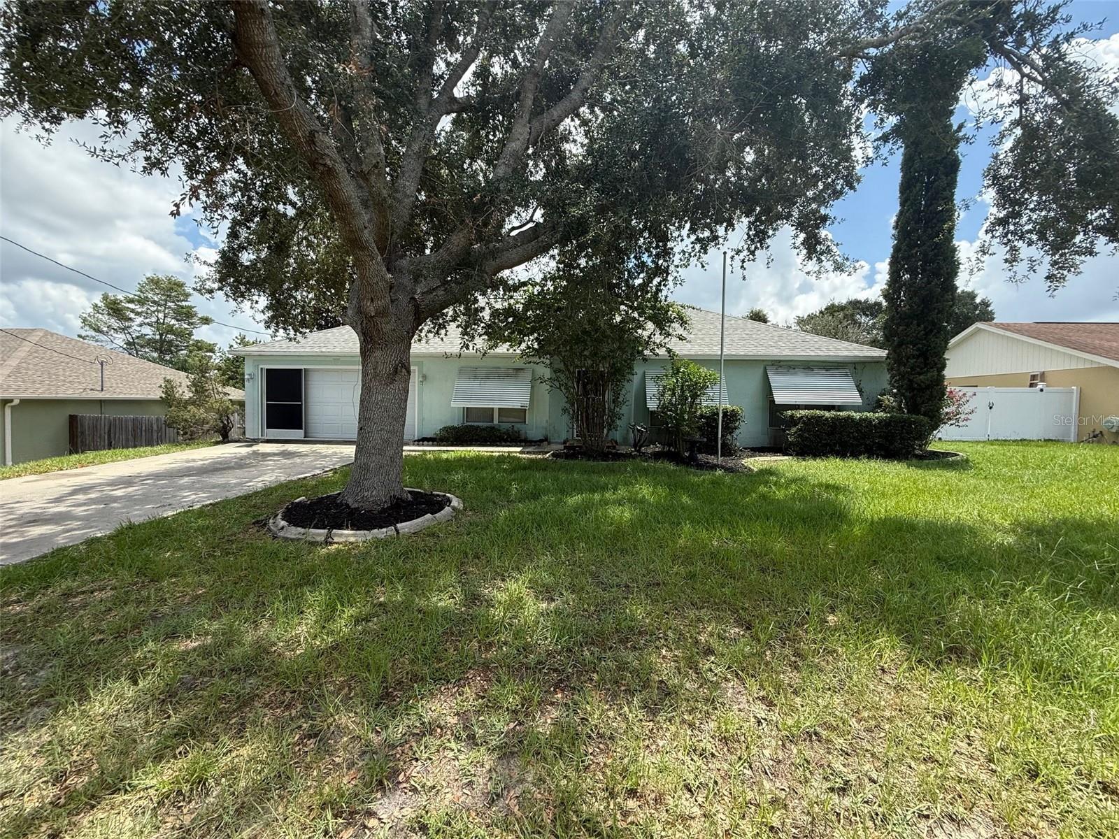 Spacious 4/2/2 with over 2200sqft offering great potential in a well-established neighborhood. This property features a split floor plan with generous living areas, a formal dining space, and a large kitchen with an island, double pantry, and plenty of room to redesign to your taste. The primary suite includes double walk-in closets and en-suite bath with a garden tub and separate shower, while three additional bedrooms provide flexibility for guests, a home office, or hobby space. Major improvements have already been made — the roof and HVAC system are both newer (roof from 2021 and HVAC from 2023), offering peace of mind for the big-ticket items. Outside, you'll find a screened porch overlooking a private backyard ready for your landscaping vision. Whether you're an investor or an end-user buyer ready to personalize your next home, this one offers a solid foundation and a desirable layout. With some cosmetic updates, it could really shine. Conveniently located - just 2 miles from US 19. Bring your vision and make it your own! Call today! This property has a repaired sinkhole.