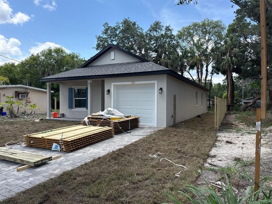 This three-bedroom, two-bathroom home spans 1,334 square feet under air and features exceptionally tall ceilings of 9 feet 4 inches throughout, and is sitting on a large 44'x145' lot. The home has been meticulously designed and optimized for ultimate functionality and spaciousness, incorporating a split floor plan for the bedrooms, an interior laundry room, and an open concept for the living area. The kitchen boasts ample counter space and an abundance of cabinetry to cater to even the most discerning clients. Additional features of this home include waterproof and scratch-resistant vinyl flooring, granite countertops in the kitchen and bathrooms, and numerous built-ins in the storage closets. The exterior of the home is adorned with a spacious covered front and back porch, and the driveway is finished with a stunning slate color paver. The oversized 1-car garage provides ample space for a car and additional storage. This is an up-and-coming, rapidly evolving area with new homes being constructed at every corner. Additionally, the home is conveniently located just 2.5 miles from the shops, bars, and restaurants of Downtown Sanford.