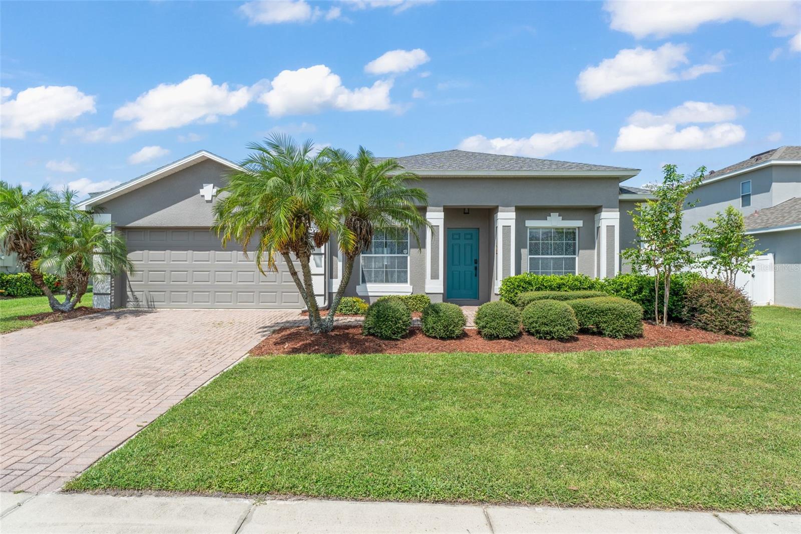 Welcome to 706 Grandhaven Way, a beautifully updated home in the heart of Winter Garden’s coveted Golf Cart District. This charming residence offers a rare perk – an unobstructed view of the July 4th fireworks over Lake Apopka, enjoyed right from your living room or spacious backyard! Thoughtful updates throughout include a brand-new roof (2024), luxury vinyl plank flooring in the main living areas and bedrooms, fresh interior paint, and stylish new light fixtures and ceiling fans that create a modern, welcoming feel.
At the heart of the home, the kitchen features granite countertops, stainless steel appliances, abundant cabinet space, and a large breakfast bar – perfect for both casual dining and entertaining. The open-concept layout allows for seamless flow between living spaces, ideal for gatherings or quiet evenings at home. The split-bedroom floor plan offers privacy and comfort. The primary suite provides a peaceful retreat with a spacious layout, dual vanities, soaking tub, and separate walk-in shower. On the opposite side of the home, three generously sized bedrooms and two full bathrooms provide plenty of room for family, guests, or a home office.
Step outside to your private backyard oasis, featuring a screened-in covered patio and an oversized paver patio – perfect for BBQs, outdoor dining, or simply relaxing. With plenty of room to entertain, garden, or even add a pool, the possibilities are endless. Covington Park is one of Winter Garden’s most desirable communities, offering a pool, clubhouse, park, and playground – all within walking distance. You’ll also enjoy direct access to the West Orange Trail and be just minutes from historic downtown Winter Garden, where local shops, restaurants, and entertainment are just a short golf cart ride away. Don’t miss the opportunity to own this Winter Garden gem, where comfort, style, and location come together beautifully.