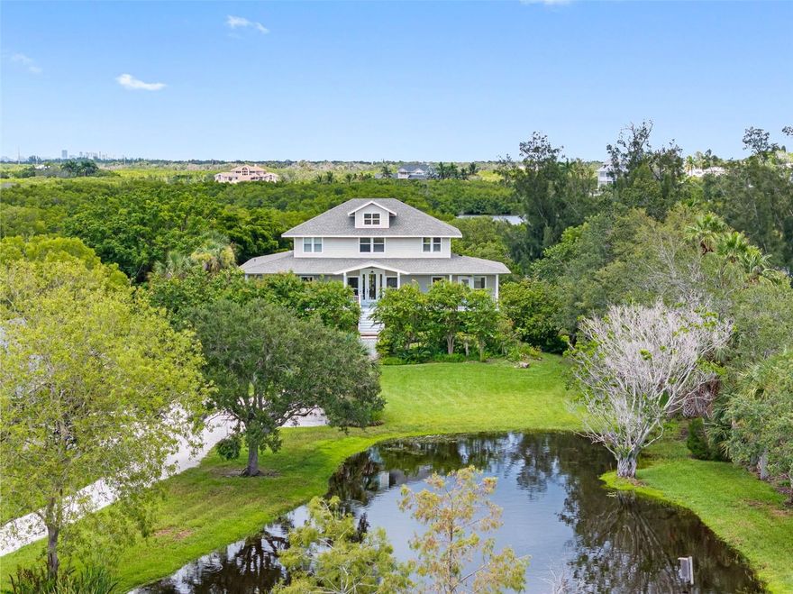 This remarkable Terra Ceia Island home stood strong through recent storms—Debby, Helene, and Milton—thanks to its elevated first floor, approximately 16 feet above ground level, providing lasting security and peace of mind. Embrace the charm of Old Florida living at 1215 Bayshore Drive, a custom waterfront residence built in 2000 featuring 4 bedrooms, 3.5 baths, and over 3,000 sq. ft. of beautifully crafted living space on 3.25 acres of serene waterfront property. A picturesque drive and lush landscaping lead to a welcoming front porch that highlights the home’s quality construction. Inside, natural light and tranquil views fill the open floor plan, where the great room, dining room, and foyer open to a screened back porch through elegant French doors. A flexible bonus room serves perfectly as an office, playroom, or TV room, complemented by a convenient half bath. The chef’s kitchen showcases custom wood cabinetry, granite counters, a gas range, stainless steel appliances, and a unique antique marble-topped oak island. A cozy breakfast nook and oversized laundry room—with a 1920s cast iron farm sink and walk-in pantry—add practicality and charm. A guest ensuite on the main level features a walk-in closet and stylish bath with beehive tile flooring and walk-in shower. Upstairs, the spacious primary suite offers a walk-in closet, updated spa bath with Jacuzzi tub, open shower, and dual vanities. Two additional bedrooms and a full bath complete the upper level. Notable features include custom millwork, ceiling fans throughout, a whole-house vacuum system, alarm system, and framed space for a future elevator. The ground level provides two covered parking spaces, a mudroom, and ample storage areas. Outdoors, enjoy a 23' x 24' air-conditioned workshop/studio with attic storage, a freshwater pond with artesian well, a fenced vegetable garden, solar-powered gate, and multiple parking options for vehicles or boats. Follow the 125-ft boardwalk to the observation deck for kayaking or fishing adventures. Ideally located near Sarasota, Bradenton, St. Petersburg, and Tampa—and minutes from the Gulf beaches—this property offers the perfect blend of tranquility, craftsmanship, and coastal accessibility. Experience the timeless appeal of Terra Ceia Island, home to Florida’s oldest continuously operating civic association. For more information: https://www.terraceiavia.com
