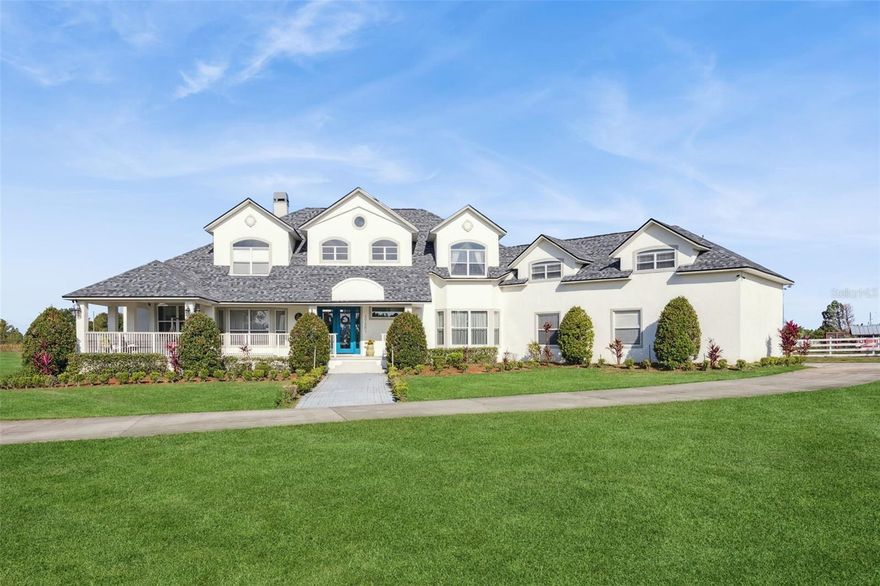 Discover Winter Garden’s best-kept secret in Avalon Estates, a peaceful, horse-friendly enclave where timeless country charm meets modern luxury. This custom-built residence offers an impressive 6,400 sq. ft. under air and nearly 10,000 sq. ft. under roof, set on 4.6 picturesque acres surrounded by nature and serenity.
From the moment you arrive, the inviting curb appeal and sprawling front porch set the tone for what awaits inside. Step through the double entry doors into a grand living space filled with soaring ceilings, abundant natural light, and an airy, open feel that defines Florida living at its finest.
The modern farmhouse kitchen is a dream for entertaining, featuring two expansive islands, generous counter space, and seamless flow into the family room, where a wood-burning fireplace adds warmth and charm. French doors open to the pool area, complete with two oversized covered lanais, creating an ideal setting for relaxing or hosting guests.
The downstairs primary suite is both spacious and inviting, featuring a private fireplace, large walk-in closet, and a magazine-worthy en suite bath. A private office sits just off the primary suite, offering a quiet retreat for work or study.
Upstairs, you’ll find a large bonus room with kitchenette, three additional bedrooms, and two full bathrooms—perfect for family or guests. Don’t miss the panoramic views through the large windows—on clear nights, you can watch Disney fireworks sparkle in the distance and even catch NASA rocket launches from the east coast.
Built with poured concrete tilt-wall construction, this home is as strong and resilient as it is beautiful. The laundry room doubles as a safe room, featuring metal doors, bullet-resistant glass, and reinforced concrete walls and ceiling.
Additional highlights include a new roof (2025), an attached three-car garage, plus a detached 2.5-car garage with studio and full bath—ideal for guest quarters, an office, or hobby space.
Located just minutes from shopping, dining, and major highways (Florida Turnpike, 429, and 408), this estate is 11 miles from Disney World, 12 miles from Universal Studios, and 23 miles from Orlando International Airport.
With its combination of space, craftsmanship, and location, this property also offers excellent potential as a luxury short-term rental.
Experience the tranquility and grandeur of Avalon Estates—schedule your private tour today and start creating lifelong memories in your new home.