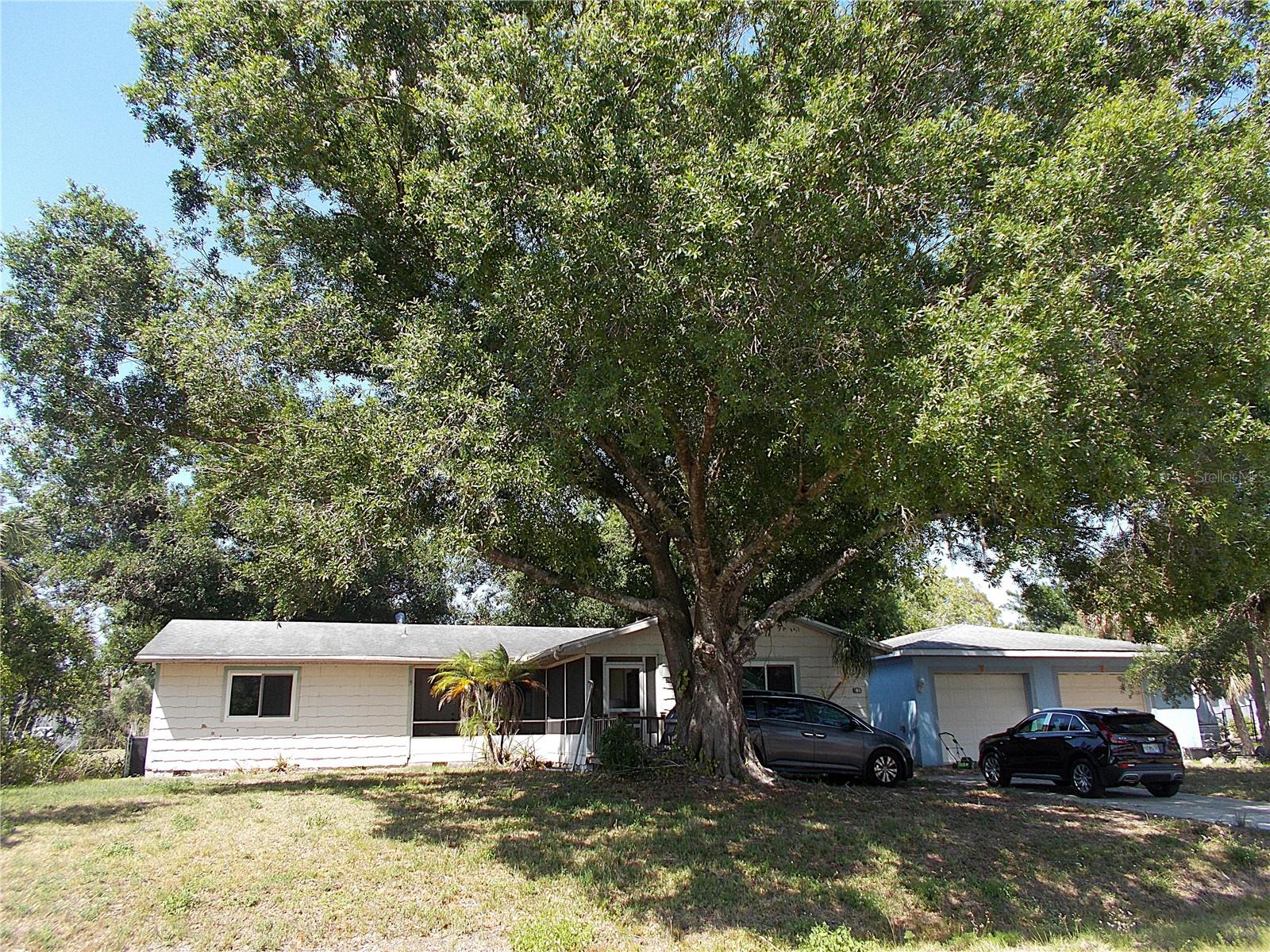 Been searching for a HUMUNGOUS garage? Look no further! This property features a 37x29 concrete block, 2 overhead door garage for all your storage needs! I'm not sure how many cars you can fit in there, but it's at least 4! Garage has electric and a service door. Now, back to the home - This 3 bedroom, 2 bath home sits on a 20,000 sq ft double lot, has city water and a fully fenced backyard. All windows and sliding glass door are newer, roof was replaced in 2019/2020, both bathrooms have been updated and the A/C is within a few years old. Kitchen has been gorgeously updated with granite counters, wood cabinets & stainless steel appliances. Home will require some TLC and is priced accordingly - wood siding needs attention, bedroom 2 needs flooring repairs & the fireplace chimney will need inspected. You can pick your own color palette though, as you'll want to re-paint some of the rooms. Room sizes are very generous, the double lot gives you that much sought after "elbow room" and did I mention that HUGE detached garage? Close to Cranberry Elementary, shopping, restaurants and so much more! Come take a look today and make this home your own.