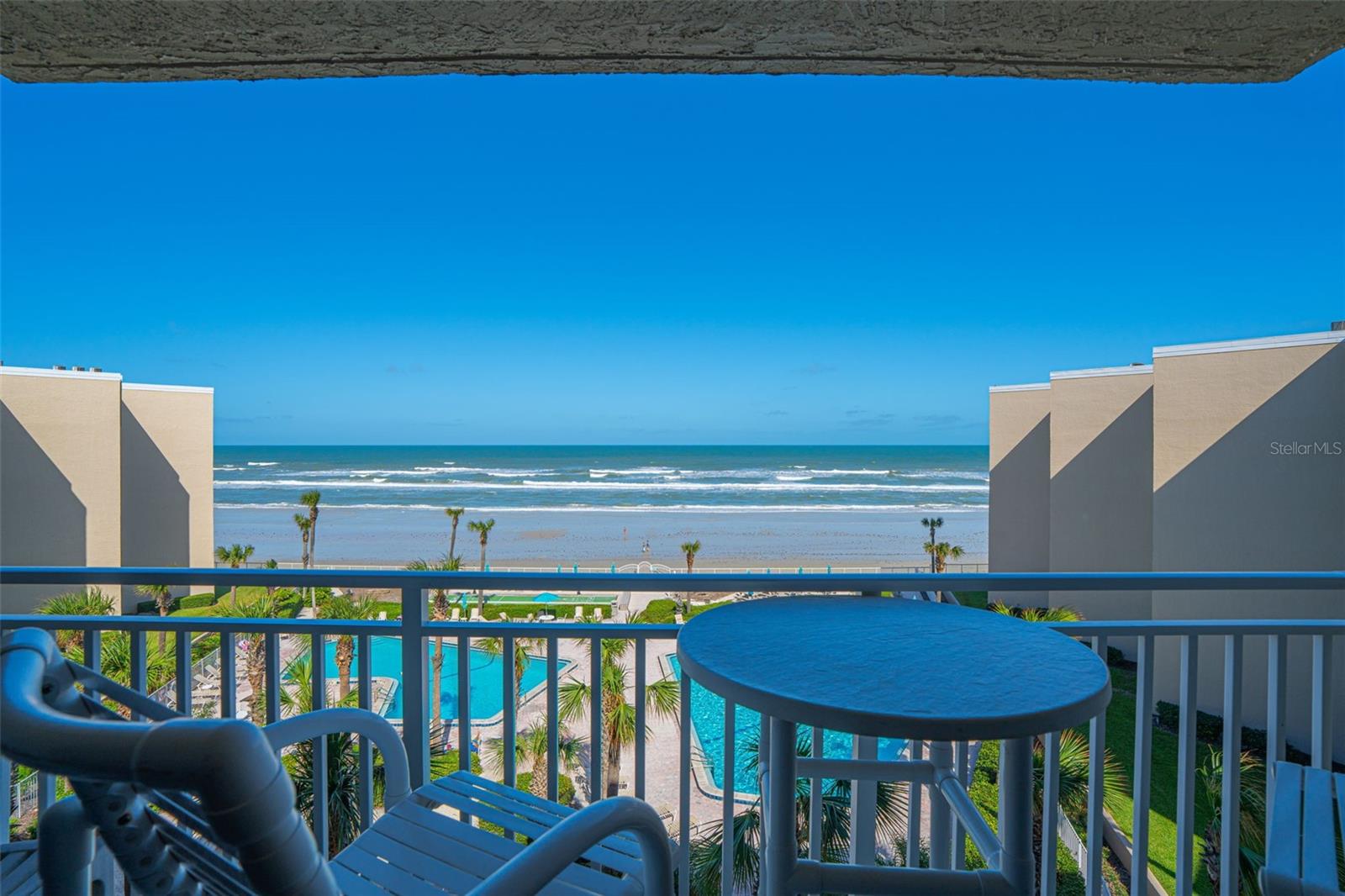 Welcome to The Pelican, one of New Smyrna Beach’s premier direct oceanfront communities, offering resort-style living and exceptional investment potential. This beautifully remodeled 2-bedroom, 2-bath condo with a bonus room is truly turnkey and ready for its next owner to enjoy the best of coastal living. The interior showcases modern finishes and a relaxed beach vibe, featuring quartz countertops, stainless steel appliances, plantation shutters, tongue-and-groove wainscoting, and durable PVC wood-look flooring throughout. Both the living area and primary bedroom open to tropical ocean views, perfect for catching sunrises and salty breezes. Wind-rated sliding doors and front windows provide peace of mind, and recent building renovations include a new front door, master window, railings, deck coatings, and exterior paint—all adding long-term value and appeal. This condo has also proven to be a strong income producer, generating $51,590 in 2024 with glowing Airbnb reviews—making it ideal for those seeking a vacation home that pays for itself. The Pelican community offers a true resort experience with amenities that include a clubhouse, two oceanfront pools (one heated seasonally), shuffleboard, gas grills, and direct beach access. Centrally located, you’re just a short walk or bike ride to Flagler Avenue’s shops, dining, and entertainment.
Whether you’re searching for a relaxing beachfront getaway, a full-time residence, or an income-producing property, this Pelican condo offers it all—style, comfort, and a front-row seat to the ocean.