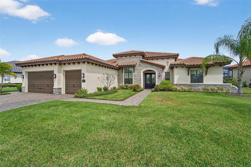 Discover a truly stunning Arthur Rutenberg home in the esteemed Sanctuary neighborhood of Grasslands Golf & Country Club. Designed for modern living, this residence showcases a sophisticated, contemporary style with an open concept and an exceptional 3-way split floor plan that ensures privacy for all.  Enjoy expansive light-filled spaces, grand double entry doors, and seamless indoor-outdoor living with dramatic sliding glass doors that frame peaceful pond views and breathtaking Florida sunrises and sunsets. The open great room is enhanced by soaring ceilings and elegant crown molding, flowing easily to a spacious screened lanai. This inviting outdoor retreat features a summer kitchen, plenty of covered space for dining and relaxation, an electric fireplace, panoramic vistas and plenty of room for a pool.  Large chef’s kitchen with solid wood cabinetry, granite countertops, center island, hidden pantry, breakfast bar, and a dedicated coffee station. Flexible dining spaces and a generous open layout designed for effortless entertaining or comfortable family gatherings.  Best of all Three-way split plan offers privacy: Luxurious primary suite with pond views, spa bath, dual walk-in closets, and a spacious walk-in shower.  Two bedrooms with a shared full bath, ideal for family or guests. Third private guest suite with its own en suite bath, perfect for visitors or multi-generational living. There are impressive upgrades throughout this home:  Gorgeous wood plank tile throughout living areas, Interior laundry with custom cabinetry and sink, Tankless hot water system, Dual-zone A/C, Oversized climate-controlled 3-car garage (third one for a golf cart) with epoxy floors.  Enjoy  24-hour guard-gated entrance, and premier privacy—all within Grasslands’ prestigious community.  Location Perks include:  Minutes from Lakeside Village shopping, top restaurants, entertainment, and medical facilities. Optional Grasslands Golf & Country Club membership available. Enjoy a contemporary, open, and effortlessly stylish home—best-in-class for those seeking privacy, elegance, and premier country club living in Lakeland’s Grasslands. This is sanctuary reimagined, move-in ready, and simply exceptional.