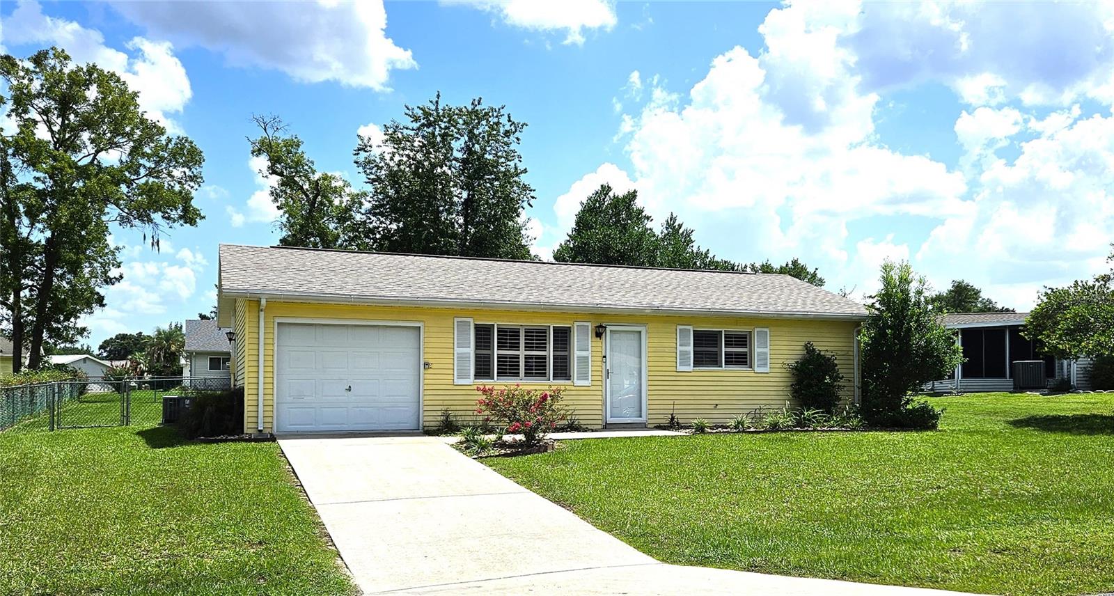 This two-bedroom, one-bathroom home features a spacious living and dining area, a Florida room under air, and a one-car garage with side entry door. The cozy ambiance is enhanced by quality plantation shutters, which also help control solar gain. You will appreciate the spotless tile flooring, the comfortable carpeted bedrooms, and the updated bathroom. The fully fenced yard with two gates provides a quiet retreat and protection for your pet. The roof was replaced in 2025.
Located in the safe and secure, 24-hour gated community of Palm Cay, this community is designed for residents aged 55 and older and boasts a low management fee. The community has a real sense of camaraderie. The Oasis clubhouse offers a variety of amenities, including planned social events, a library, billiards, a card room, an arts and crafts room, a community pool, and a tennis court.
The low management fee covers trash removal, access to the 24-hour guarded gate, maintenance of common areas, and use of the clubhouse facilities. This property is conveniently located in Southwest Ocala, just a short distance from shopping, restaurants, the World Equestrian Center, VA hospitals, and other healthcare facilities. Golf carts are permitted, and RV/boat storage may be available for a modest monthly fee. The property is just minutes from I-75, one hour from Gainesville, and one and a half hours from Disney.