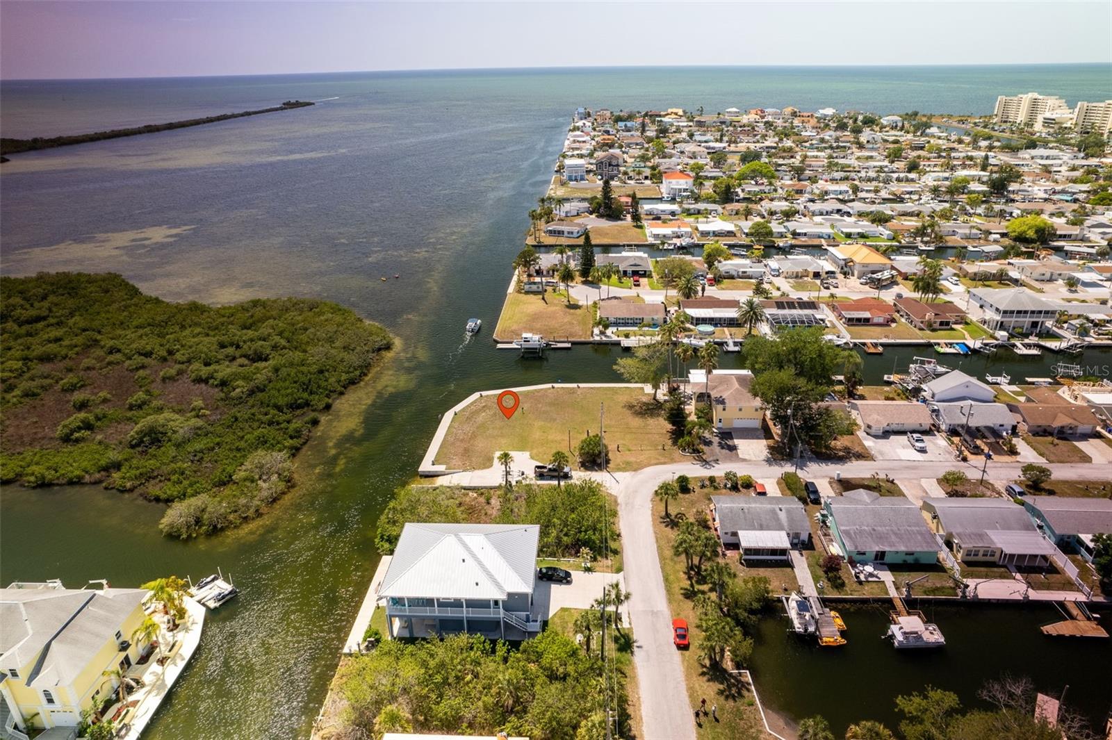 Rare Gulf Front Double Lot. This beautiful building lot is one of the largest waterfront lots in the area with 176 feet of new concrete seawall and private boatlift to accommodate your boating needs. You have the option of not being as restricted to the size and design of the home you can build or the option to subdivide the property into 2 separate parcels. Property offers some of the best onshore fishing in the area with a freshwater spring within casting distance of the seawall! Enjoying incredible views of the Gulf of Mexico and fabulous sunsets along with viewings of dolphins and manatees will become an everyday part of life. Located in a quiet boating and golfcart community at the northern edge of Werner-Boyce Salt Springs State Park, where you can fish, kayak and enjoy the serene home to a variety of marine birds and wildlife. Hudson Beach is just a short golfcart or boat ride away and offers great restaurants, entertainment, 4 marinas, boat rentals, charter fishing, public boat ramp and a beach area for swimming. Nearby Sunwest Park with over a mile of Clearwater Beach quality sand, is a beautiful County Park where swimming, wakeboarding, beach volleyball, splash pad can be enjoyed by family and friends. Close to many amenities including, medical services, hospitals, shopping and more.45 minutes to Tampa International Airport, 2 hrs. to Orlando. Building and financing information available.