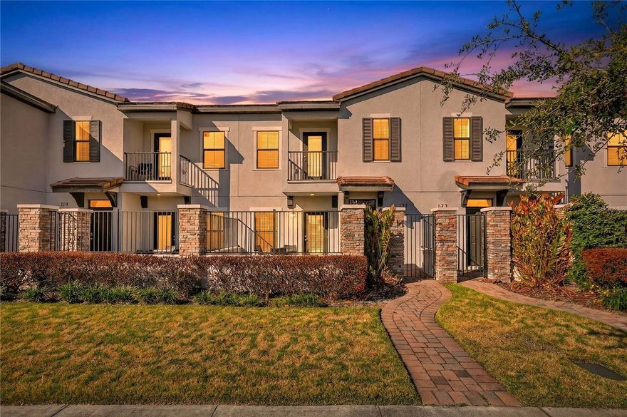 Fully furnished luxury townhome located in the highly sought-after Balmoral at Waters Edge Resort, offering a rare 2-bedroom, 2-bath dual primary suite layout ideal for full-time living, a vacation home, or short-term rental use.From the moment you arrive, you’re welcomed by a private gated patio, perfect for outdoor relaxation. The first level features a spacious bedroom suite, a full-size laundry room, and a two-car garage, providing both comfort and functionality. Upstairs, the home opens into a bright and inviting main living area designed for gathering and entertaining, along with the oversized primary suite and access to a private balcony—ideal for enjoying Florida mornings or evening breezes.One of the home’s standout features is its prime location just steps from the clubhouse, placing world-class resort amenities right outside your door. Balmoral Resort delivers an unmatched lifestyle experience, featuring a water park with multiple slides, kids’ water playground, splash pad, expansive resort-style pool, private cabanas, poolside bar and grill, fitness center, arcade, and event spaces—all designed to create a true vacation-at-home atmosphere.Centrally located, the community offers convenient access to Walt Disney World, LEGOLAND Florida, shopping, dining, and major Central Florida attractions, making this an exceptional option for owners and guests alike.Turnkey, stylish, and surrounded by resort amenities—this townhome delivers vacation living at its finest. Schedule your private showing today.