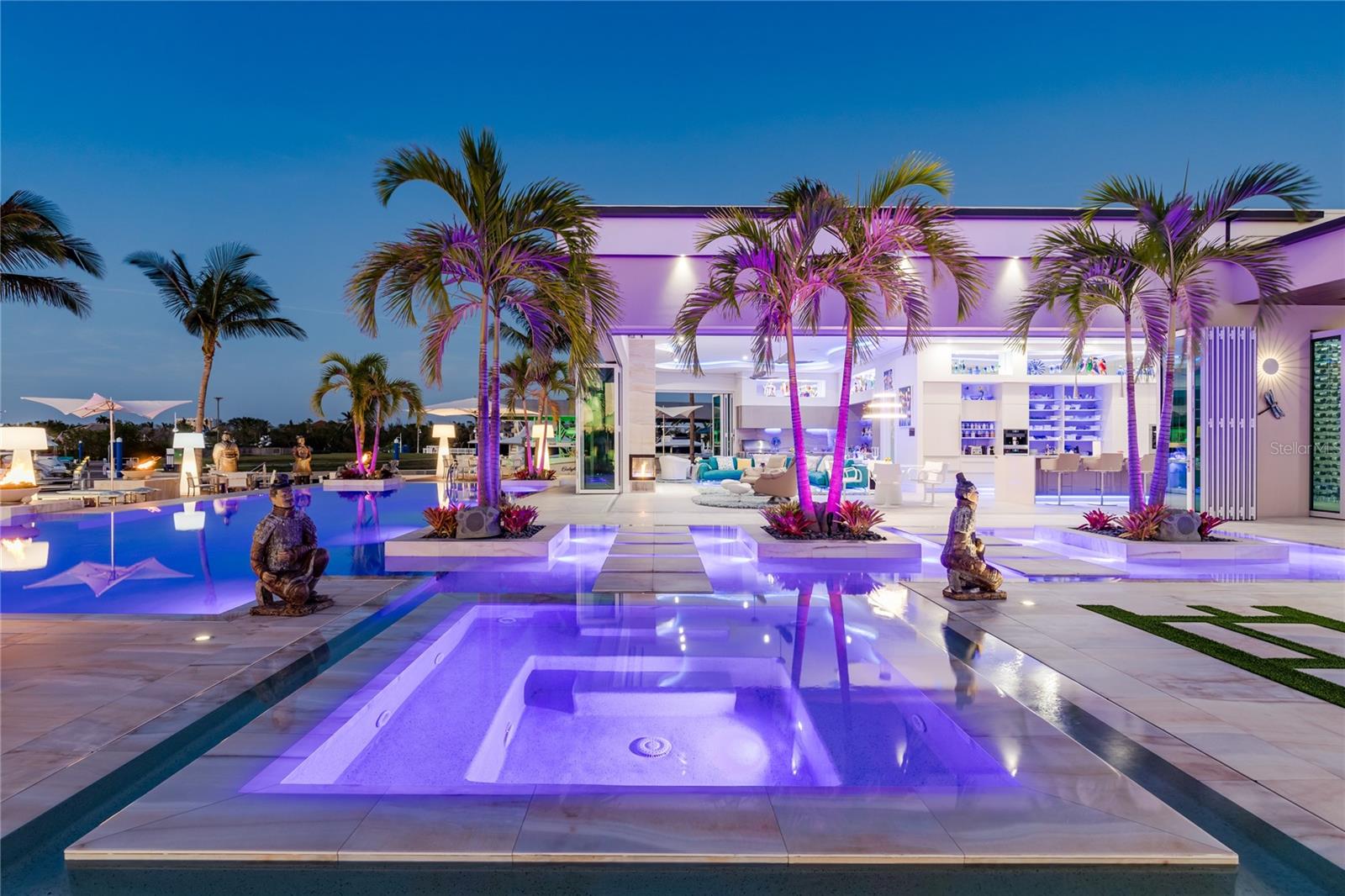 Under contract-accepting backup offers. Ultra-Luxury: The epitome of luxury living - a Yachter's Paradise! Welcome to Fort Myers most EXQUISITE and a masterpiece, boasting an opulent 271 ft wrap-around dock, 2 floating docks, a boat lift and direct Gulf access in a private, quiet idle speed zone. This residence features a mega entertainment deck with an expansive outdoor living area, a zero-edge pool, spa, a party room and an incredible sound & lighting system, ideal for entertainment! This Masterpiece with a total of 14,000 sq.ft (including 6,200 sq.ft under air) is located on a 1/2-acre in a cul-de-sac. Inspired by contemporary architecture, it showcases ultimate interior features, offers luminous open living areas, coveted design elements, the finest materials, 20 ft soaring ceilings, a spacious great room, foyer, a chef's kitchen with luxury high-end kitchen appliances, 38 sun tunnels, and a glass wine room. The primary suite occupies the west wing, the guest bedrooms are located on the east wing. The garage is suitable for 8 cars. Great location, 15 mins to the private airport, 20 mins to the international airport, close to fine dining, shopping, beaches. The ultimate lifestyle!