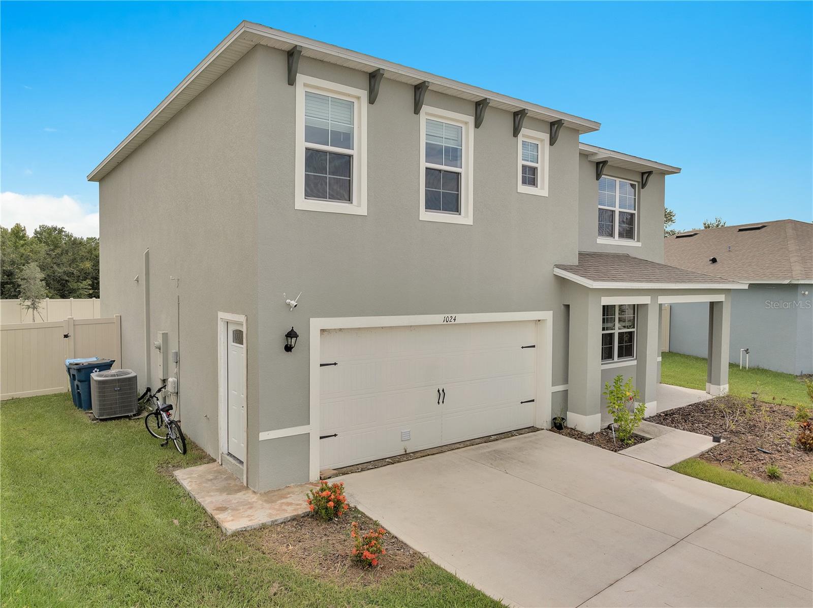 Built in 2023, this spacious 6-bedroom, 3-bathroom home sits on an oversized, fenced premium lot in Davenport. The main home features 4 bedrooms, 2 baths, an open-concept layout, a modern kitchen with island seating and stainless steel appliances, plus a flex room, loft, and upstairs laundry. The garage has been converted into a 2-bedroom, 1-bath in-law suite with its own kitchen appliances, perfect for visiting family or as a source of rental income with tenants already in place. Additional highlights include a covered lanai, smart home technology package, and prime location near shopping, dining, medical facilities, and major roadways.