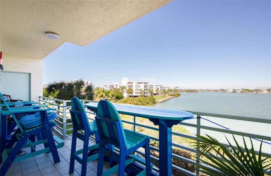 This luxury condo has breathtaking views of Boca Ciega Bay. It’s located in a 24 hr Guard Gated island community developed by award winning JMC Communities. This desirable corner unit comes with two spacious balconies. The living room has unobstructed wide water views. The kitchen has been recently remodeled and reconfigured to maximize the view. The kitchen also features new wood cabinets, new stainless appliances, beautiful marble countertops and a breakfast area overlooking the water with additional custom cabinetry. This is a two bedroom, two bath unit with a den/office/bonus room. All rooms were completely remodeled with a decorator's touch. The primary bathroom is spectacular with a beautiful turquoise square sink, and all the backsplash is stone and glass (very contemporary). also granite counters. The guest bathroom has quartz counters, seashells in the backsplash and new shower tile. Both bathrooms have shower towers. The main living area is an open floor plan with 9' ceilings throughout. There is crown molding in the living room and dining room and an indoor laundry with full sized washer and dryer in the hall. The primary bedroom has an ensuite bath and walk in closet. The building passed the milestone inspection. The roof on the building was replaced in 2024. The light and airy atmosphere is welcoming to enjoy the tropical lifestyle. If interested, furnishings can be included. This unit has a reserved under-building parking space (#127). Harbourside is a guard gated (24 hour) complex with many amenities including pool, his and hers fitness centers, shuffleboard, pickleball, tennis, hot tub, electric car charging stations, car wash stations, recently renovated clubhouse with many social events throughout the year, library, card room, billiards room, arts and crafts room, wood working area, yoga and water exercise classes. There is a 1.5 mile walkway around the complex along the waterfront which is lit up for nightly walks. Come see what resort living in Florida is all about. You can live your tropical, island dream here in Harbourside.