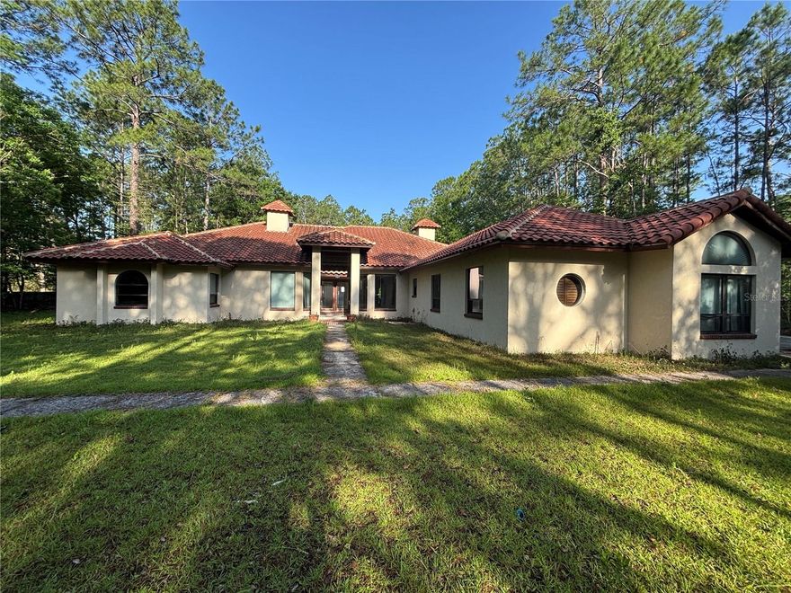 Private Gated Estate on Horse-Friendly Acreage – 10760 Skylark Dr, Jacksonville, FL

Welcome to a one-of-a-kind private retreat tucked away under soaring pines at 10760 Skylark Dr in Jacksonville. This gated estate offers rare seclusion, timeless architecture, and the freedom of no HOA, all on high and dry land zoned for horses.
The centerpiece of the property is a custom-built 4-bedroom, 3-bathroom home designed in the classic New Mexico Adobe style. Constructed with durable block and topped with a 50-year-rated concrete barrel tile roof, this home blends Southwest charm with enduring quality. Inside, you’ll find two stunning back-to-back fireplaces, ideal for creating cozy ambiance across multiple living spaces. A central vacuum system, whirlpool tub, and dual-zone air conditioning add comfort and convenience. All major systems have been recently serviced, and only cosmetic updates are needed—allowing you to make this home your own. Also included is a second dwelling: a manufactured home featuring 3 bedrooms, 2 bathrooms, and its own fireplace. While this bonus home requires significant repairs, it presents an exciting opportunity for guest quarters, rental income, or a private studio/office space. The entire property is high and dry, surrounded by majestic pine trees, offering natural beauty and privacy throughout. With no HOA restrictions, ample open space, and zoning for horses, this is an ideal setting for equestrian enthusiasts, hobby farmers, or anyone seeking a peaceful lifestyle without compromise. Enjoy the tranquility of country living just a short drive from city conveniences. Properties like this—combining privacy, architectural character, and functional flexibility—are incredibly rare. Don’t miss your chance to own this unique slice of North Florida paradise. Schedule your private tour today!